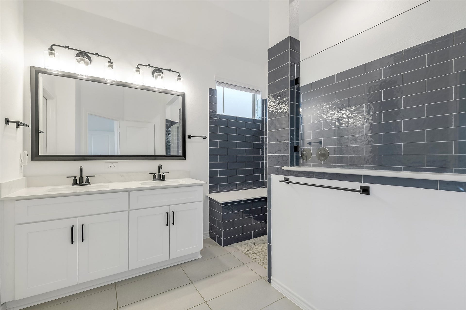 Your own private escapethe primary bath pairs clean contemporary finishes with a spacious vanity and oversized walk-in shower, creating a spa-like setting designed for unrushed mornings and relaxing evenings.