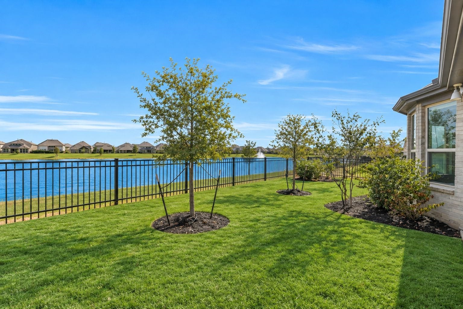 Your backyard becomes an everyday escape with an expansive lawn extending toward the lake. Enjoy wide-open water views, room to play and entertain, and the tranquility of having the waterfront just beyond your own backyard.