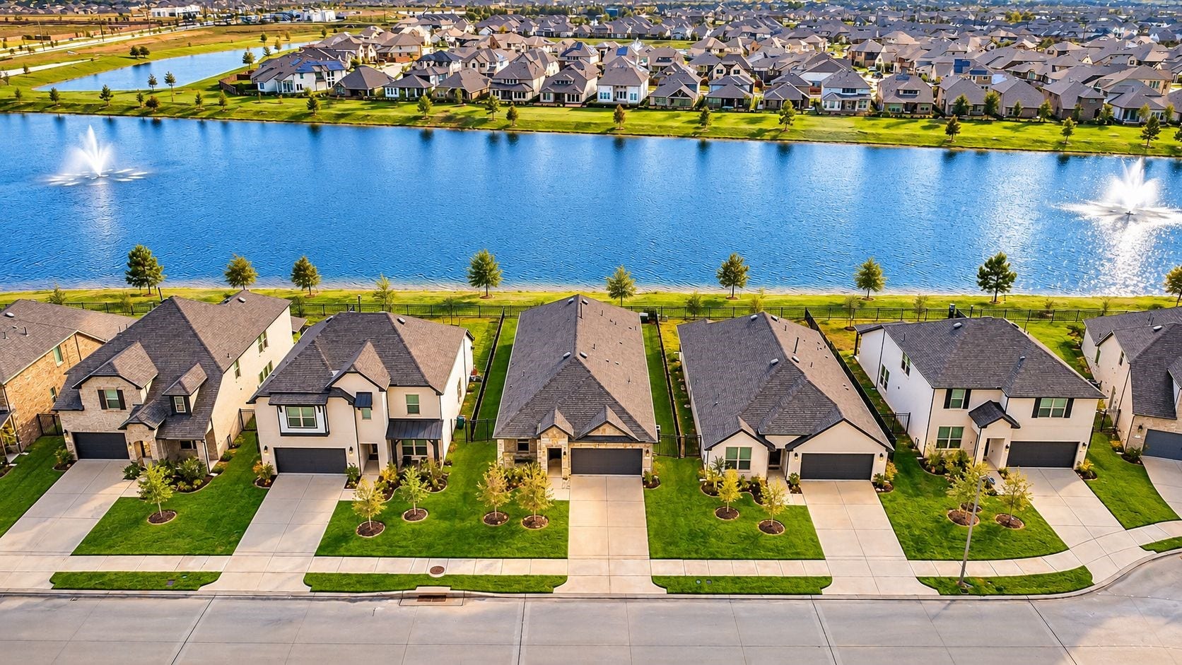 The ultimate view of the lifestylethis aerial perspective showcases the homes exceptional position along the lake, where peaceful water views, spectacular sunsets, and outdoor living become part of everyday life. A beautiful setting to call home.