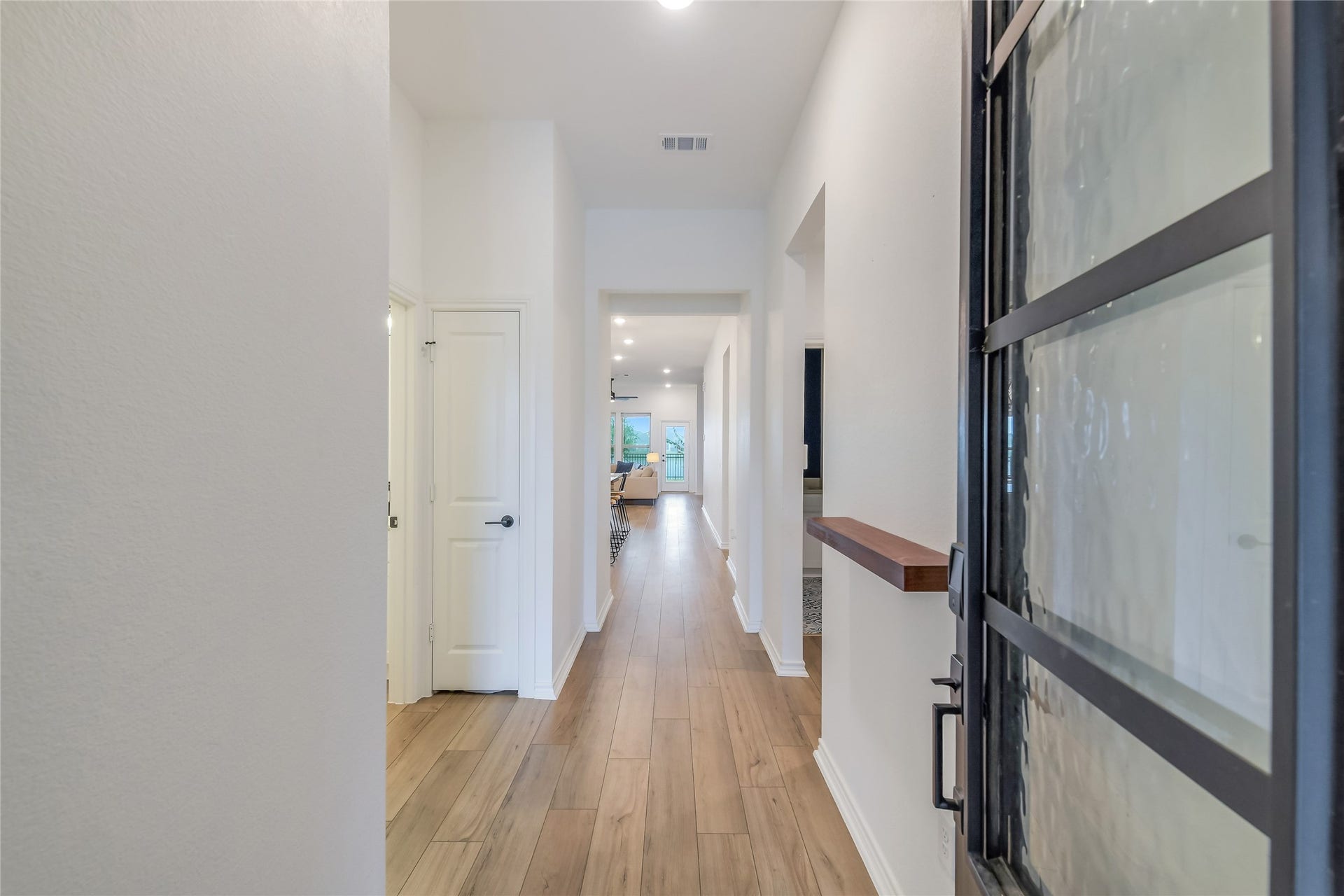 Step inside and immediately catch a glimpse of the lake beyondan inviting entry with modern finishes and a direct sightline toward the water creates an impressive first impression.