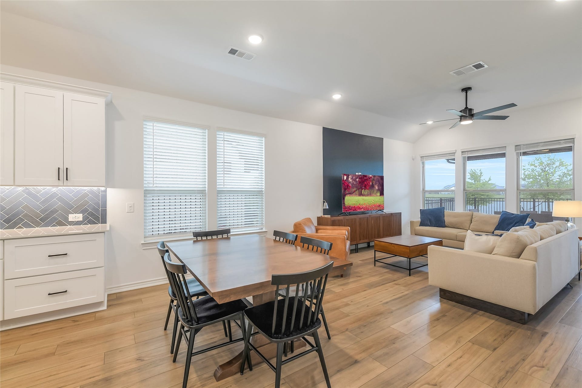 Open, airy, and designed around the viewthe kitchen, dining, and living areas come together as one impressive entertaining space with natural light and the lake providing a beautiful backdrop.