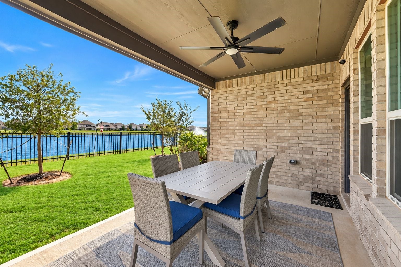 Indoor-outdoor living comes naturally here. The covered patio opens directly to the spacious backyard and lake, creating an incredible setting for morning coffee, weekend entertaining, outdoor dining, and evenings spent by the water.