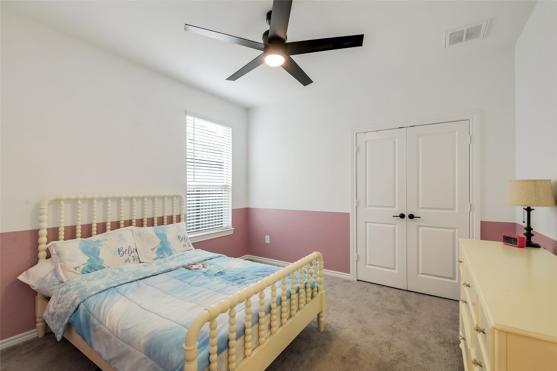 A bright and inviting secondary bedroom provides a comfortable retreat for family or guests, with plenty of flexibility to create a space that feels private and personal.