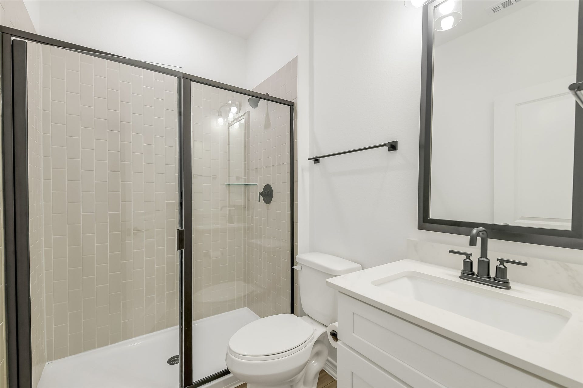 Stylish secondary bath provides a private, well-appointed space for family and overnight guests with contemporary finishes and a clean, timeless design.