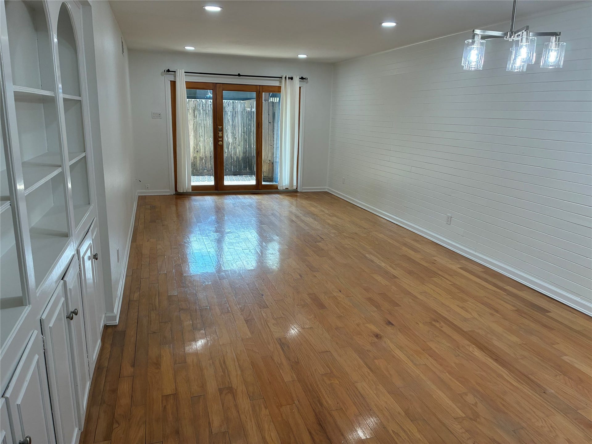 Living/Dining opens to back patio; gleaming hardwoods; built-in shelves.