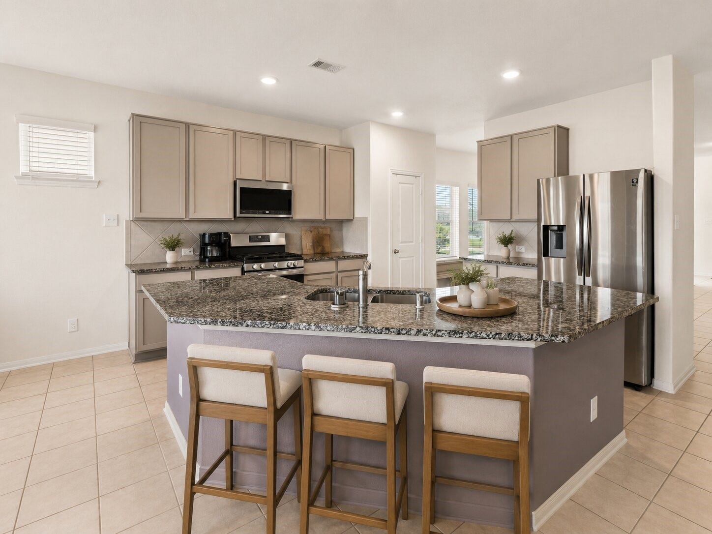 1503 Barras Street, Alvin, TX 77511 *virtually staged* A closer look at the oversized island, plentiful counter space and breakfast bar at the center of the home.