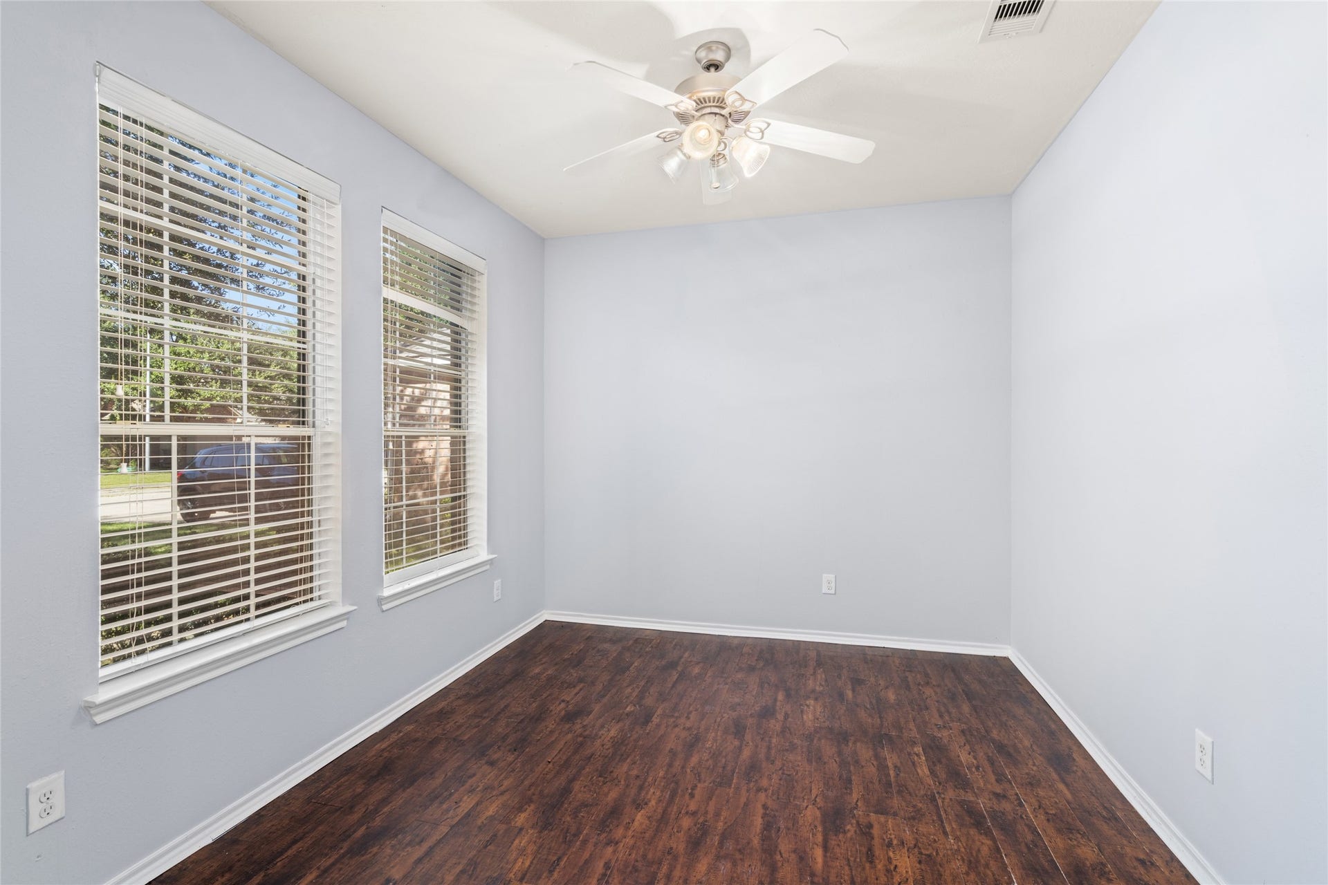 24519 Evangeline Springs Lane, Katy, TX 77494 Bright and inviting, this home office/study features abundant natural light and elegant wood flooring, creating the perfect atmosphere for productivity and focus.