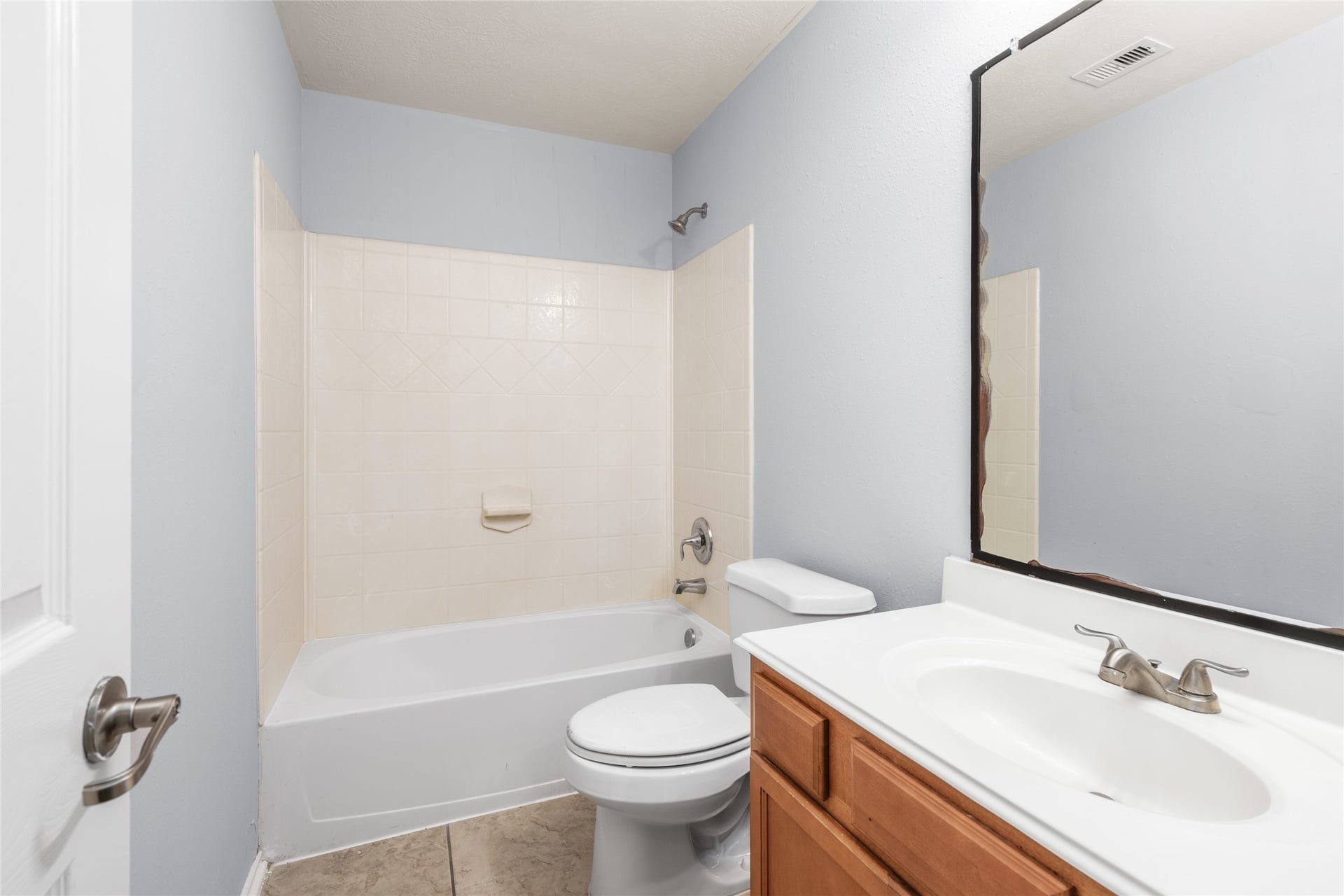 24519 Evangeline Springs Lane, Katy, TX 77494 Secondary bathroom featuring a tub-and-shower combination, vanity storage, and neutral finishes. The practical layout serves bedrooms and household members with a convenient option for both bathing and daily routines.