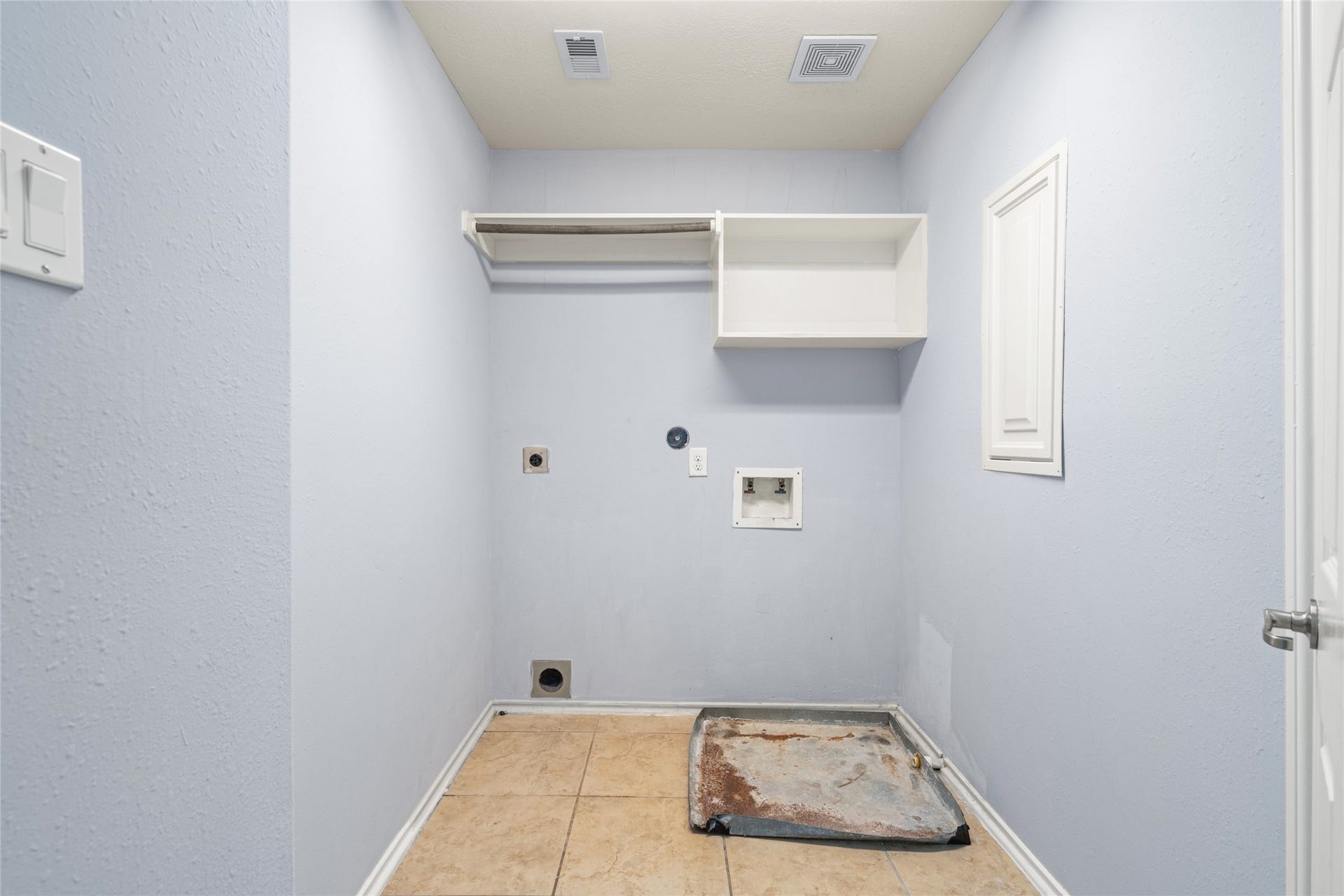 24519 Evangeline Springs Lane, Katy, TX 77494 Dedicated utility and laundry room with space for laundry appliances, wall-mounted storage, and everyday laundry supplies. Keeping laundry in a separate room helps organize household chores and frees up space in the main living areas.