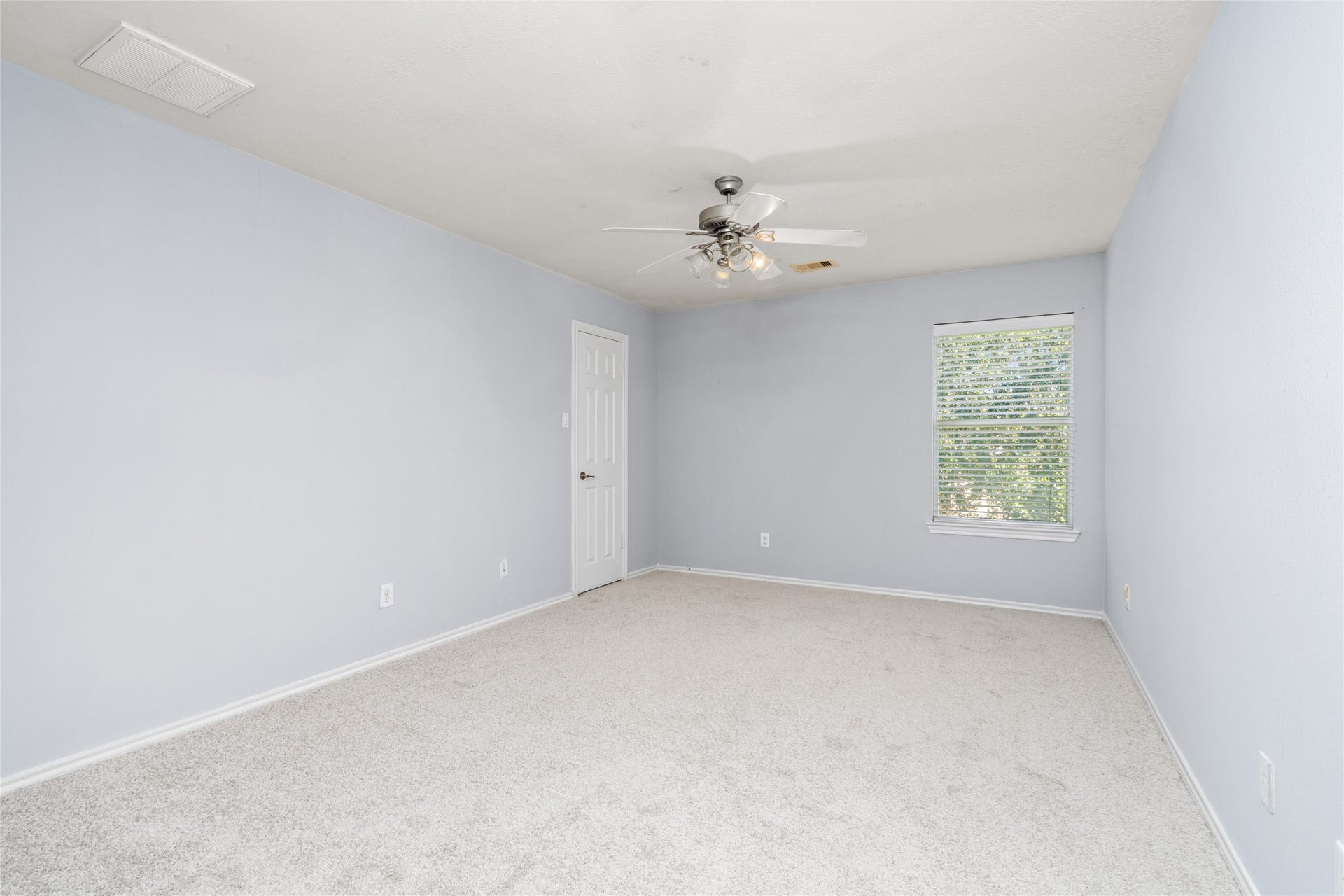 24519 Evangeline Springs Lane, Katy, TX 77494 Spacious secondary bedroom featuring soft carpeting, a ceiling fan, and a window that brings in natural light. The simple, open layout makes it easy to personalize the room for sleeping, studying, or other everyday needs.