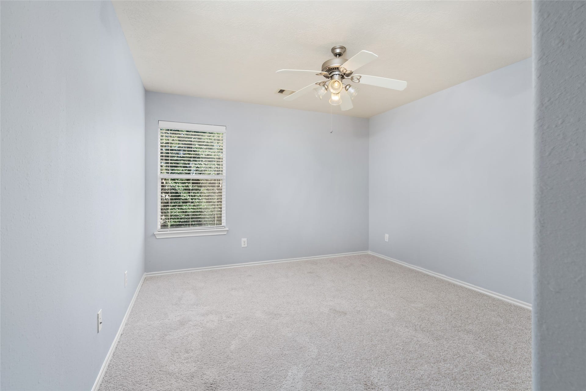 24519 Evangeline Springs Lane, Katy, TX 77494 Unfurnished secondary bedroom with soft carpeting, a window, and neutral finishes. The open layout provides flexibility for a bedroom, guest room, or personal retreat, depending on the buyer's needs.