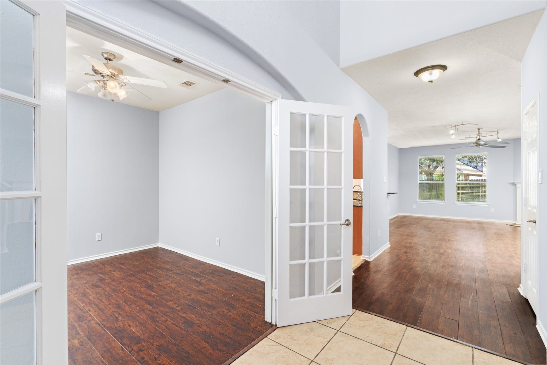 24519 Evangeline Springs Lane, Katy, TX 77494 Elegant French doors invite you into a sunlit home office or study, blending style and functionality for your work-from-home needs.