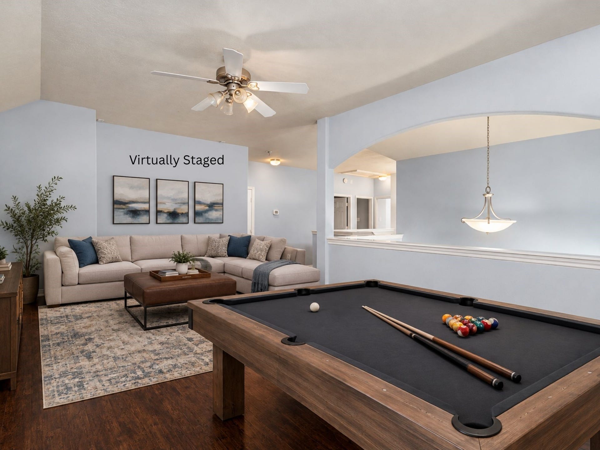 24519 Evangeline Springs Lane, Katy, TX 77494 Virtually staged second-floor game room featuring wood flooring and an open layout arranged for recreation and entertaining. The room offers a dedicated space for games, hobbies, movie nights, or a casual gathering area away from the main living room.