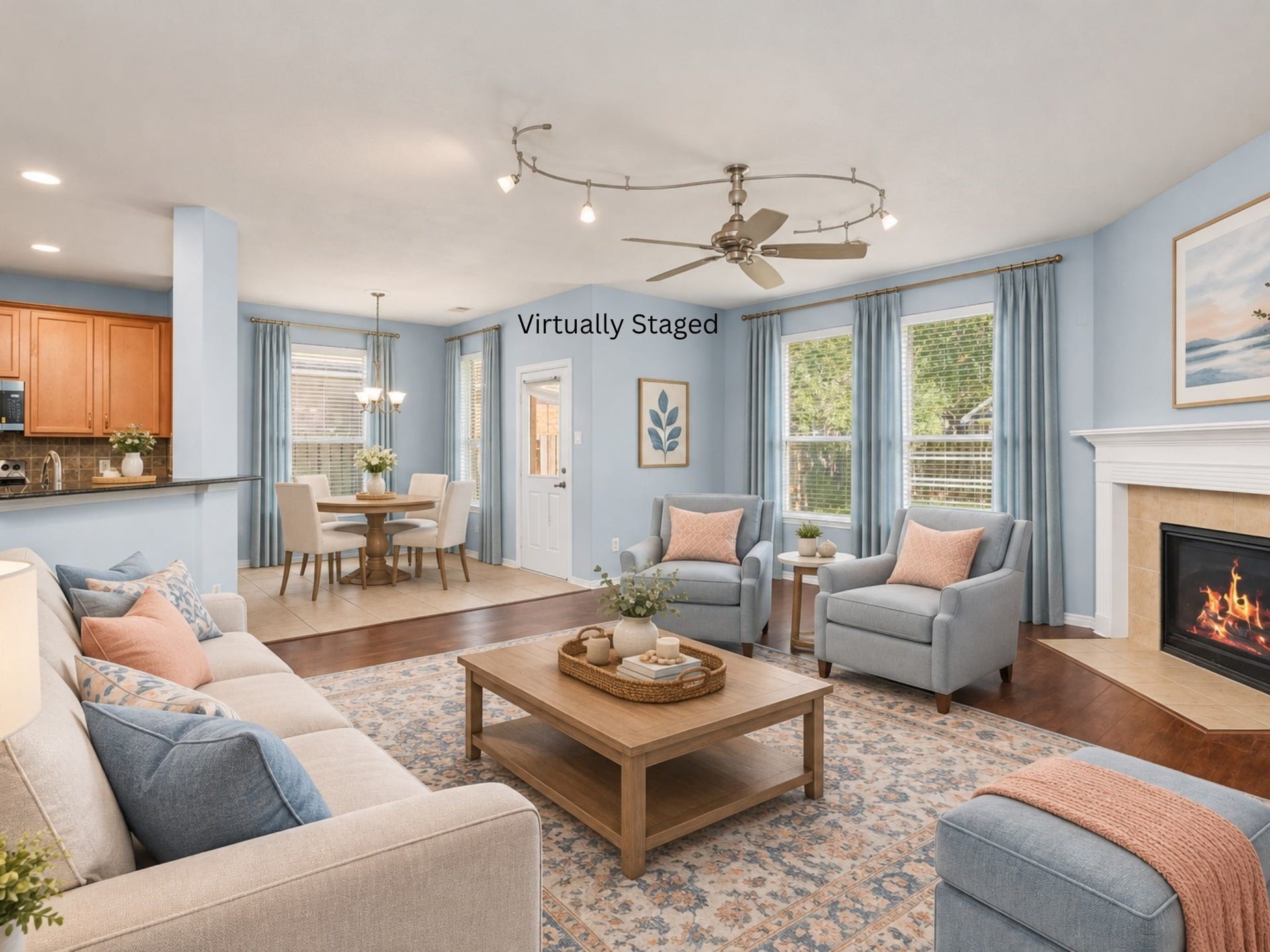 24519 Evangeline Springs Lane, Katy, TX 77494 Virtually staged living room illustrating how the open space can accommodate a comfortable seating arrangement. The fireplace, wood flooring, and connection to the kitchen help create a welcoming setting for gathering with family and friends.