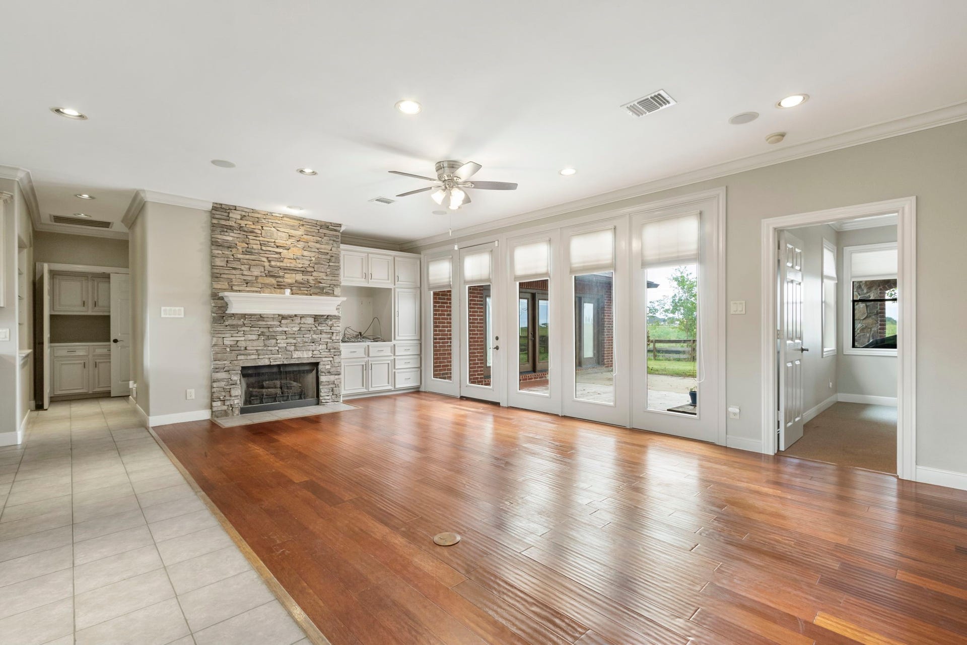 7806 Spirit Hollow Court, Missouri City, TX 77459 Family Room with a gas log fireplace. A wall of doors let to the outside patio.