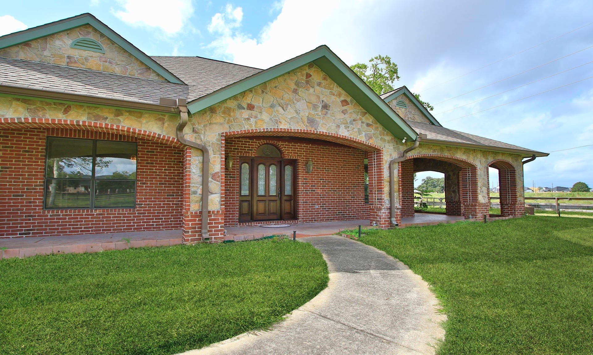 7806 Spirit Hollow Court, Missouri City, TX 77459 The home is made of brick and stone with covered patio on most sides.