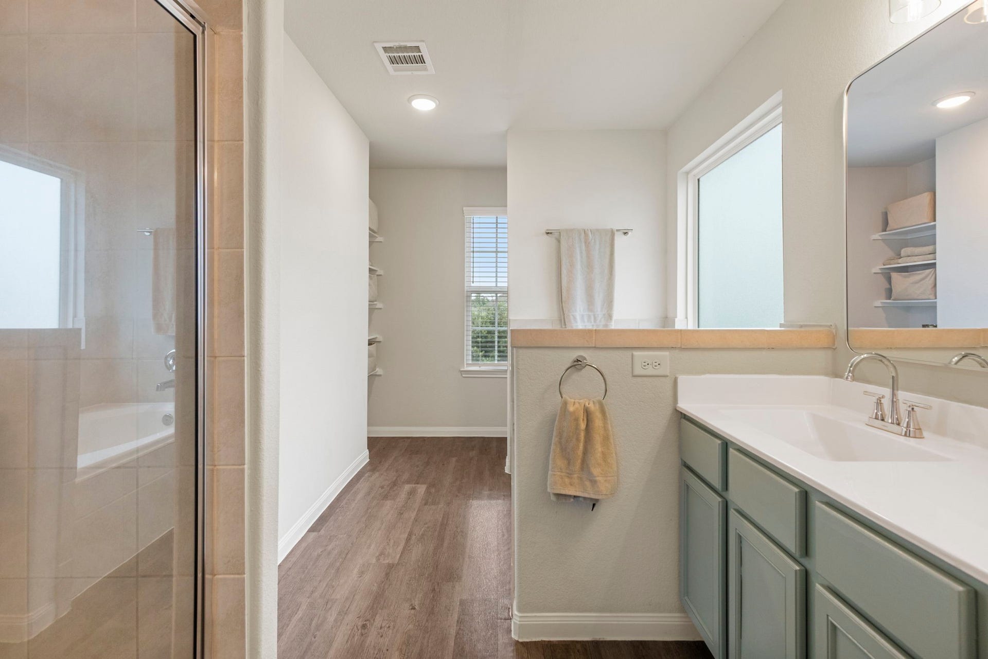 Well-appointed primary bathroom offers a comfortable and functional space for everyday convenience.