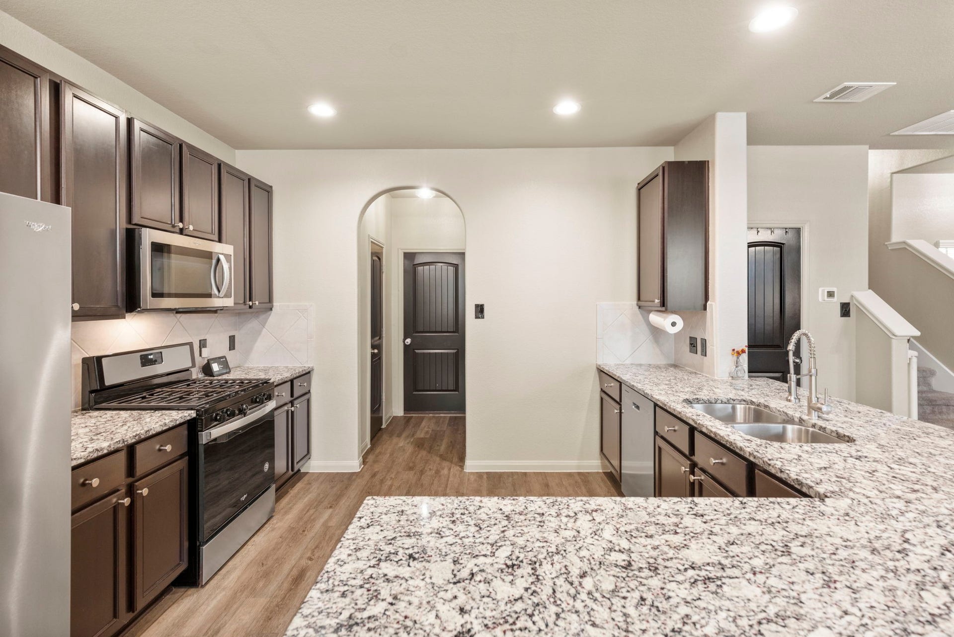 The kitchen offers ample countertop and cabinet space for added functionality and storage.