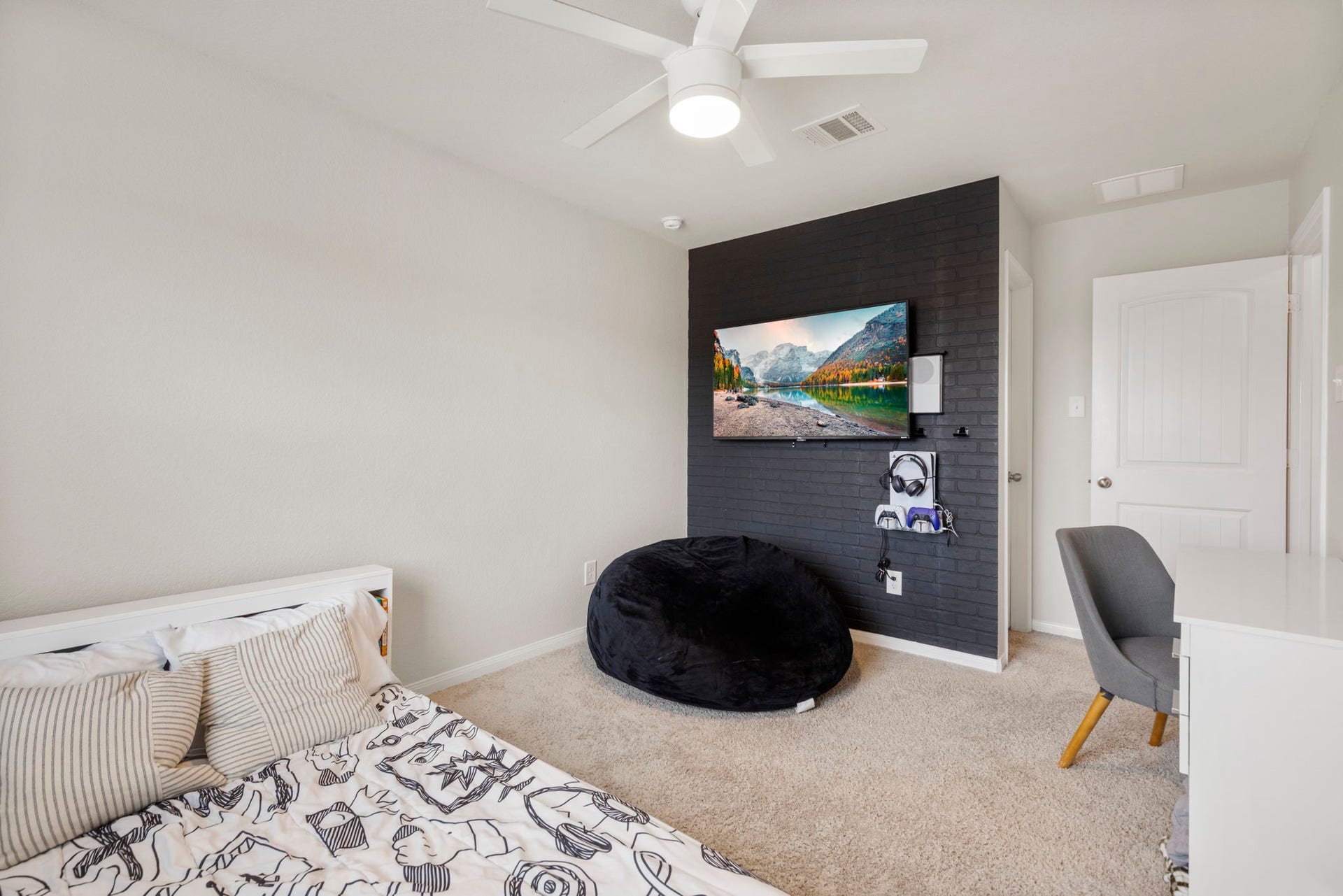 This secondary bedroom is complete with a stylish accent wall.
