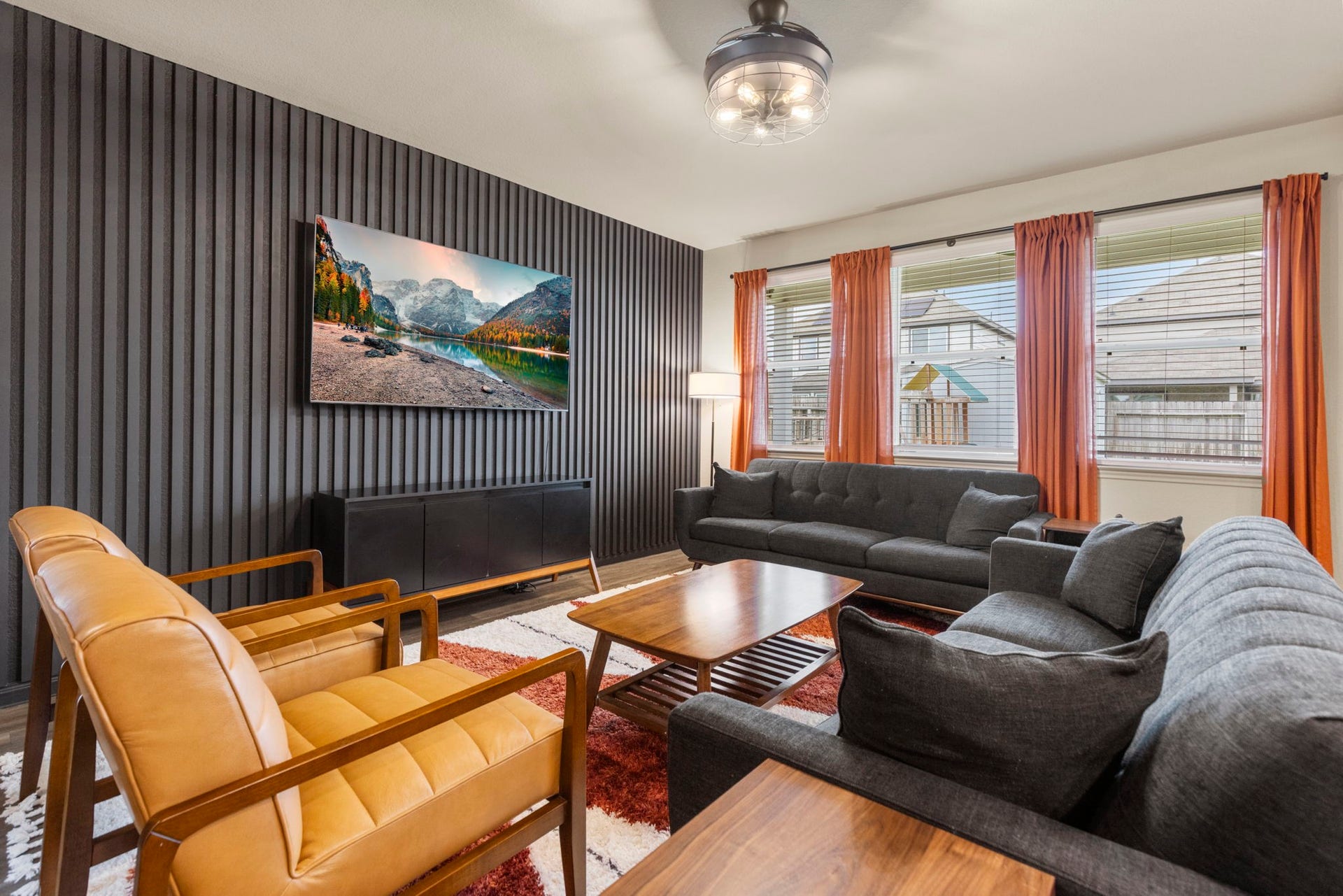 The living room has an abundance of natural light from the large windows.