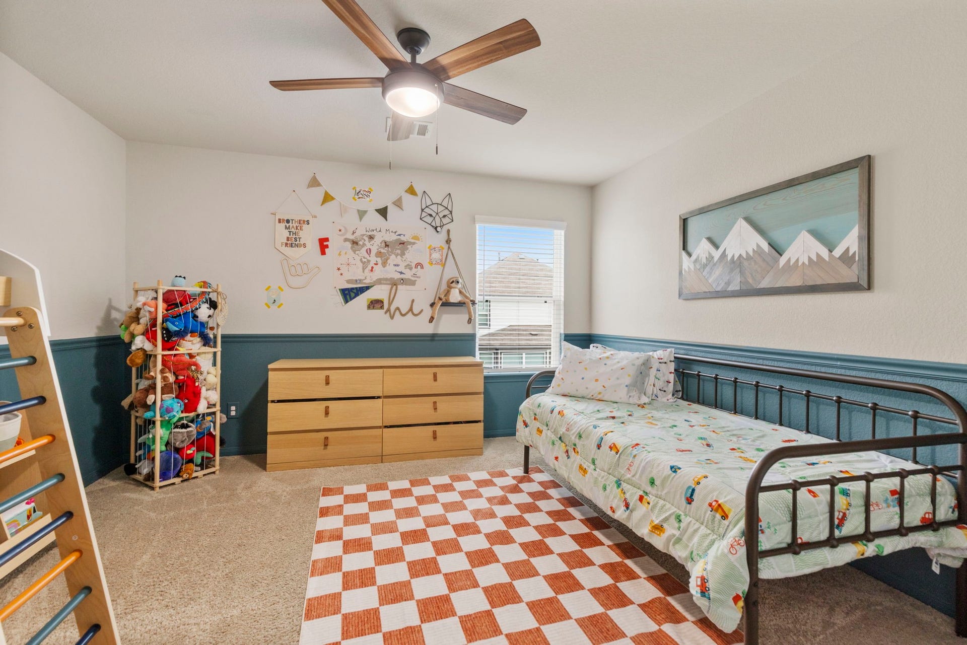 This secondary bedroom is complete with a wainscoting accent wall.