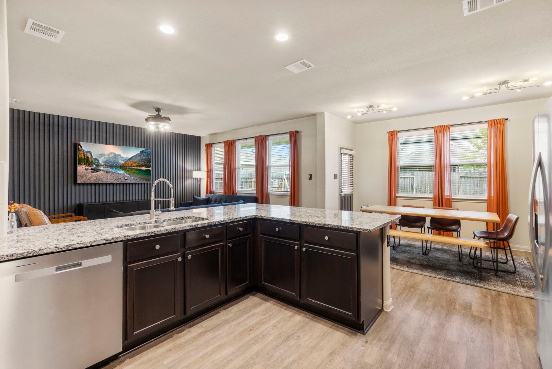 The open kitchen provides a functional space for preparing meals while remaining connected to the main living areas.