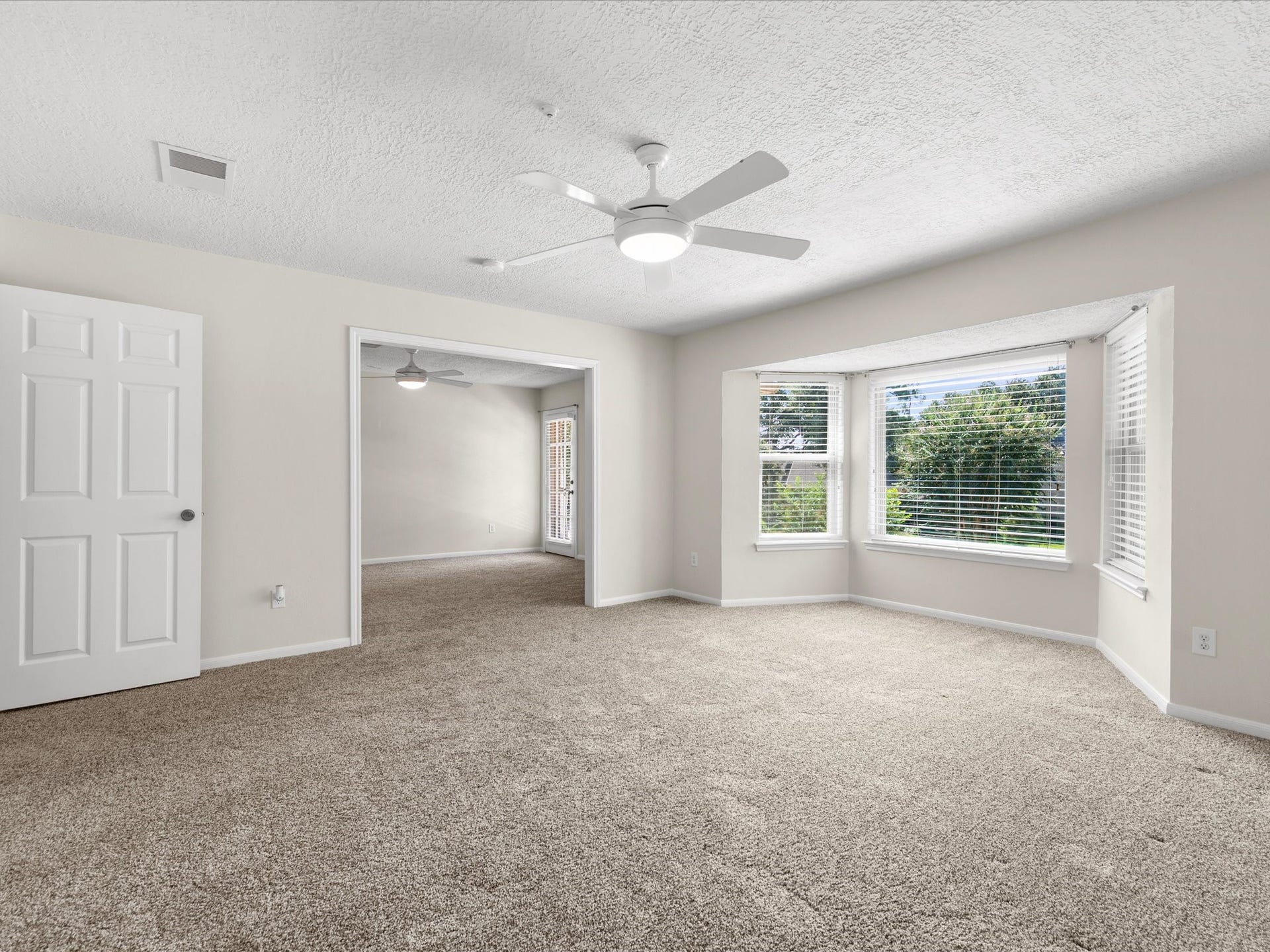 15902 Cumbria Drive, Spring, TX 77379 Upstairs bedroom with a bay window and an opening to the next room.