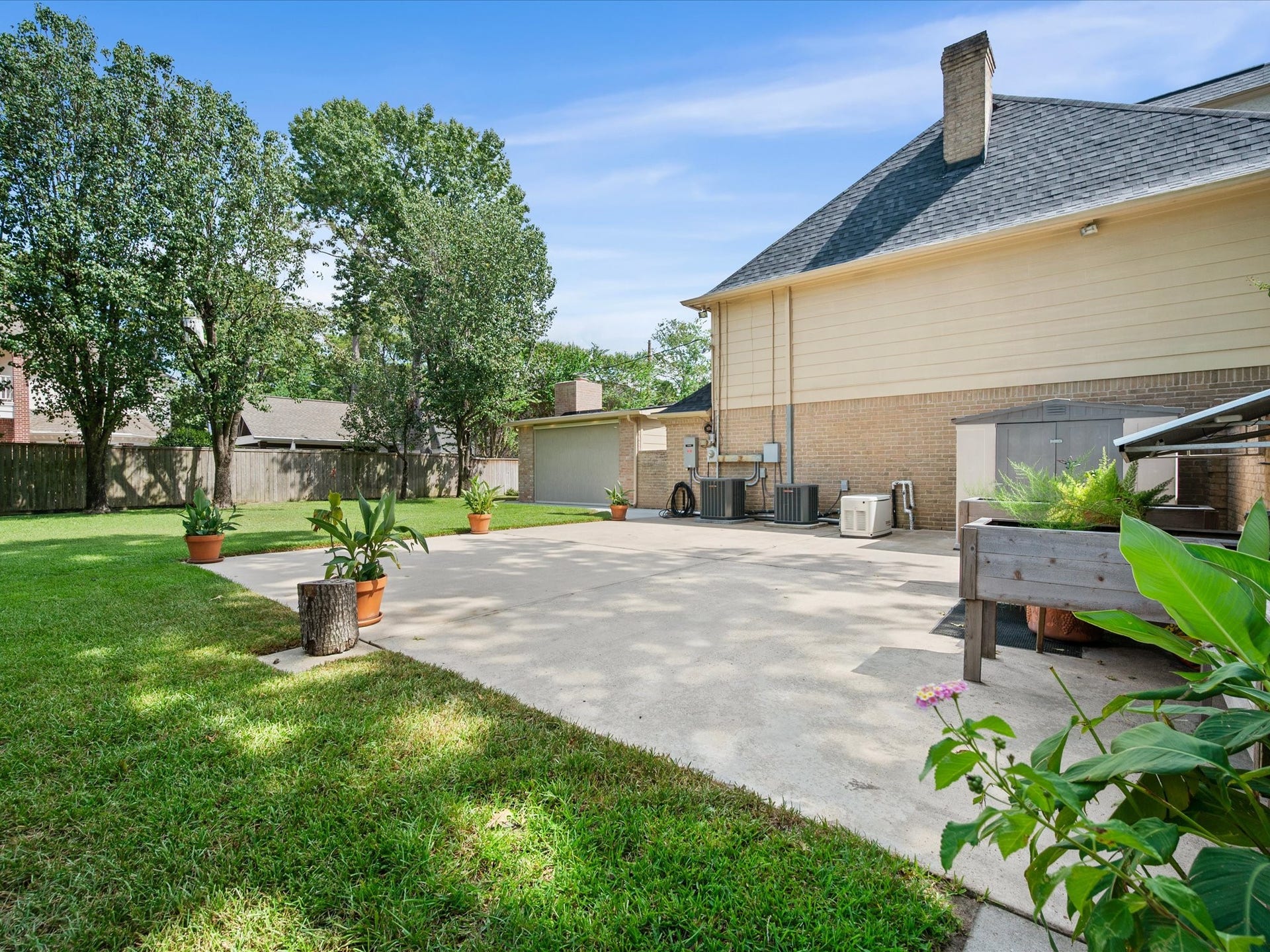 15902 Cumbria Drive, Spring, TX 77379 A paved area off the back of the garage, with lawn on both sides.