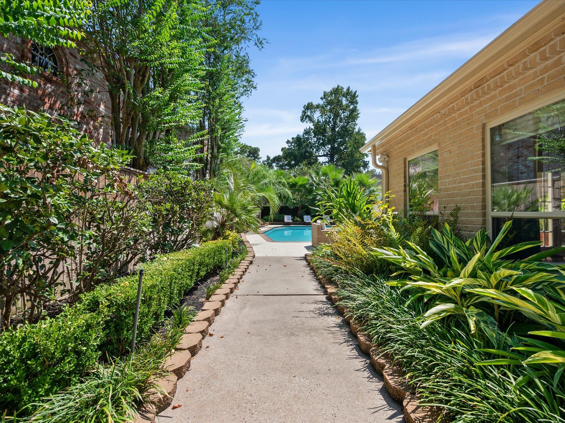 15902 Cumbria Drive, Spring, TX 77379 A landscaped side yard path leads around to the pool.