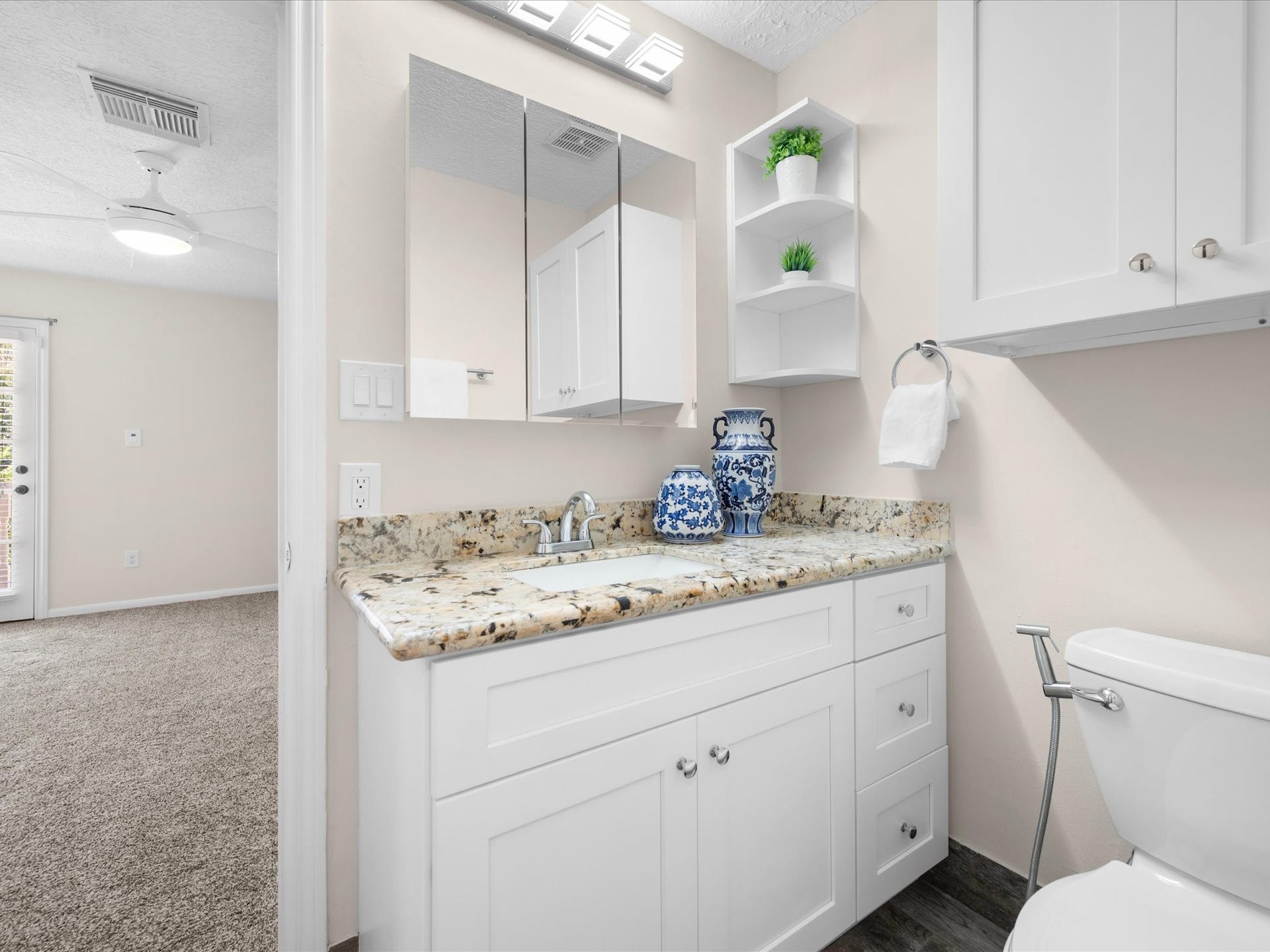 15902 Cumbria Drive, Spring, TX 77379 The remodeled upstairs full bath. Granite counter, white cabinets, and open shelving.