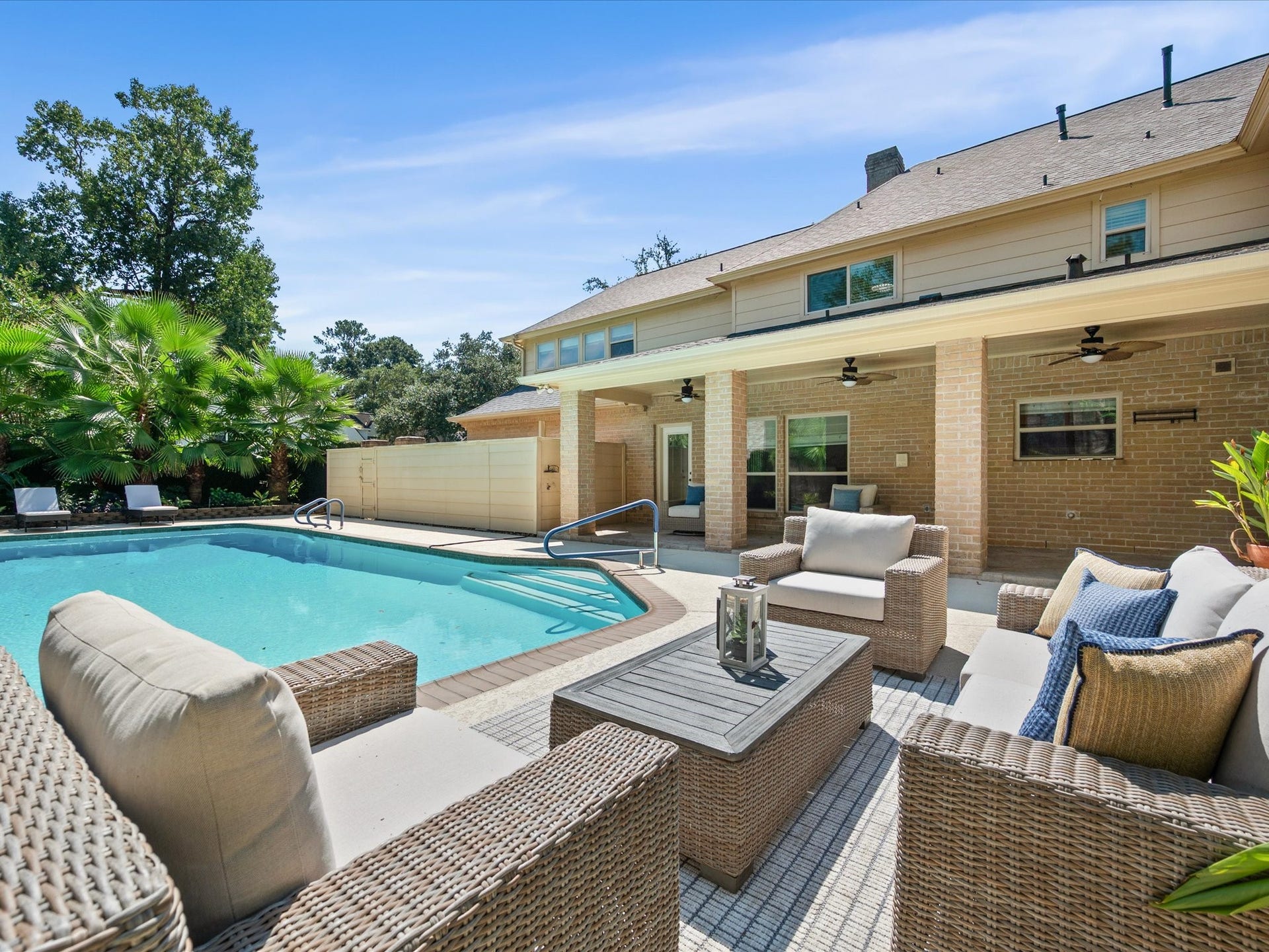 15902 Cumbria Drive, Spring, TX 77379 The pool and the back of the house, with the covered patio running along the ground floor.