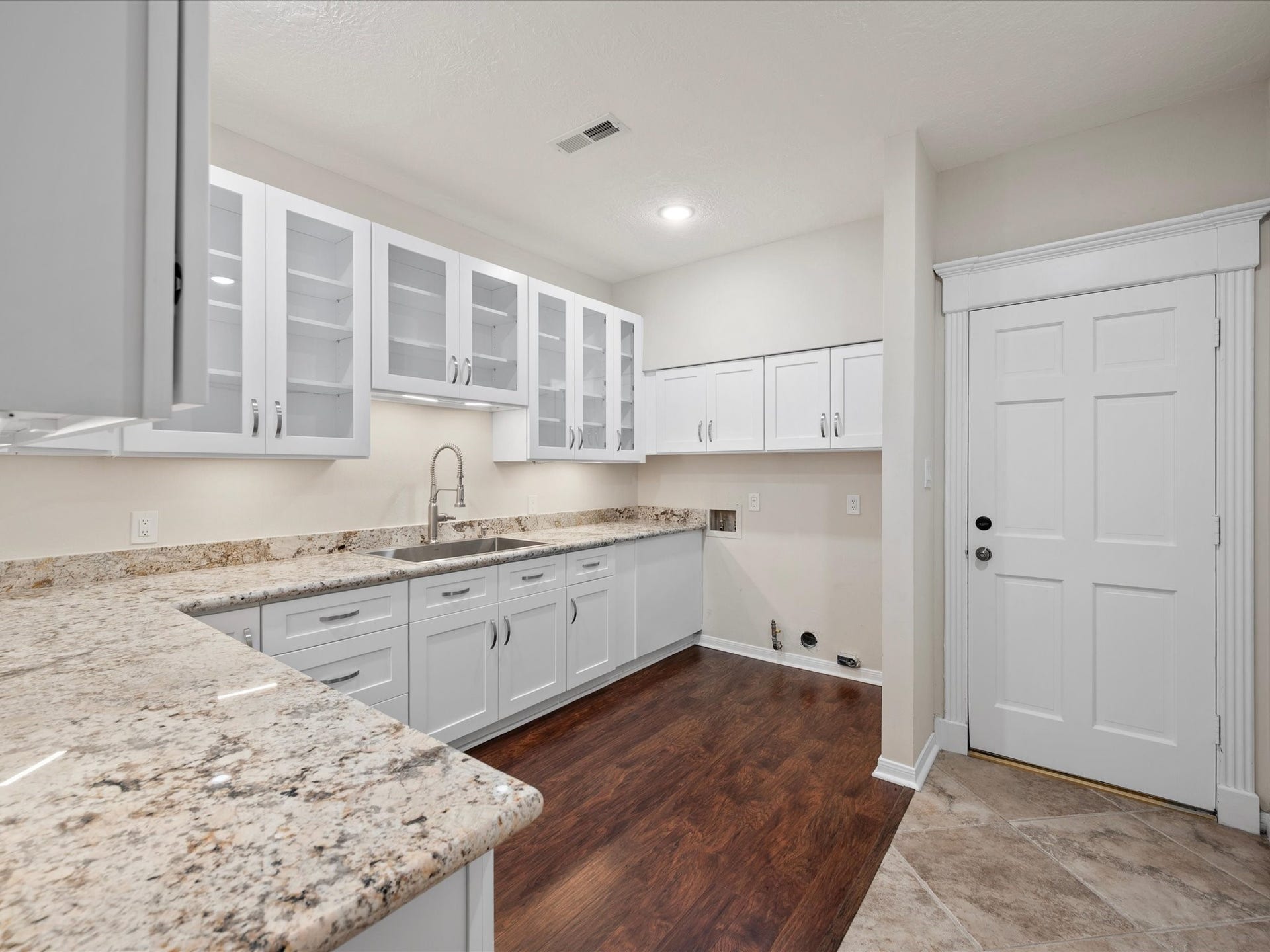 15902 Cumbria Drive, Spring, TX 77379 The laundry room was rebuilt with granite counters, custom white cabinets, and a sink.