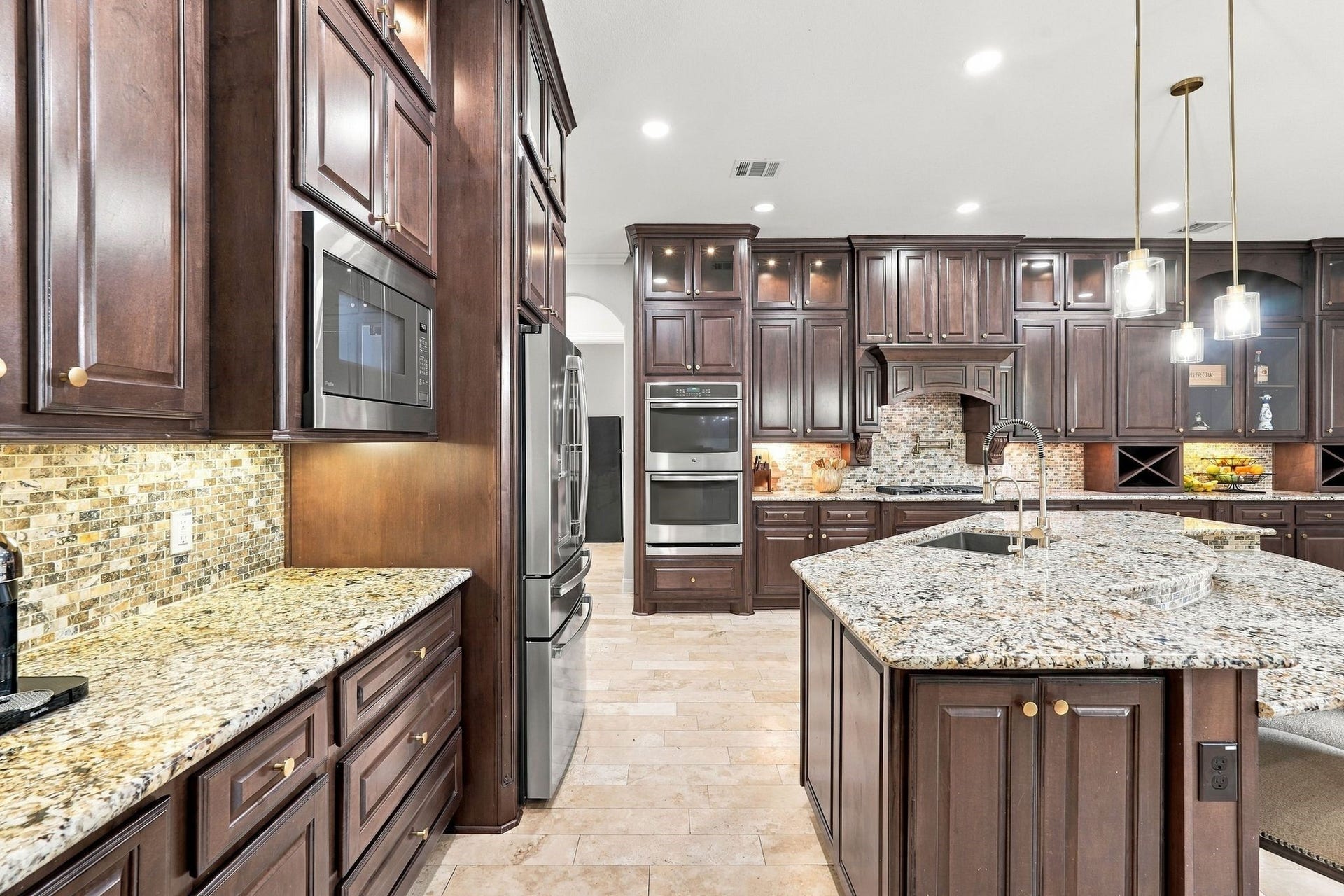 13714 Arcott Bend Drive, Tomball, TX 77377 This kitchen is massiive and comes with a new dishwahser (2024), Stainless wine chiller (2024) and new refrigerator (2024) which all stay!