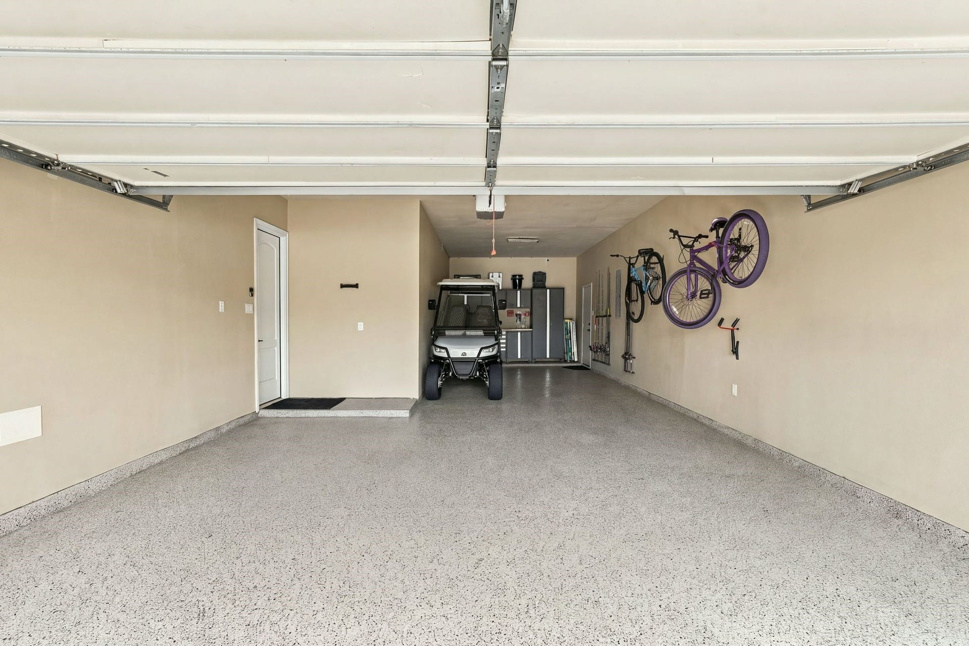 13714 Arcott Bend Drive, Tomball, TX 77377 Spacious 3-car tandem garage featuring durable epoxy flooring, overhead storage, wall-mounted organization, and a dedicated workspace. Impressive depth and generous floor space provide exceptional flexibility for multiple vehicles, recreational equipment, and additional storage.