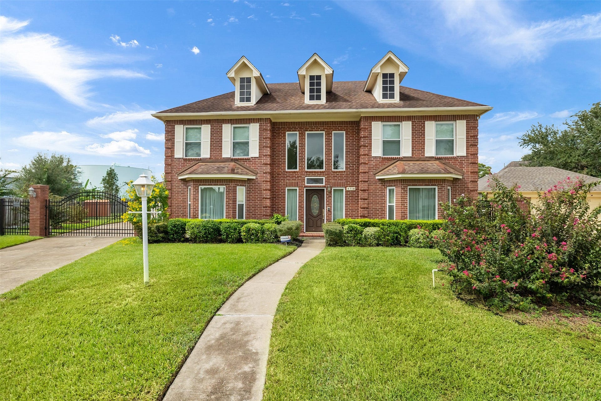 9718 Deverell Drive, Sugar Land, TX 77498 A winding walkway and oversized driveway make a charming first impression.