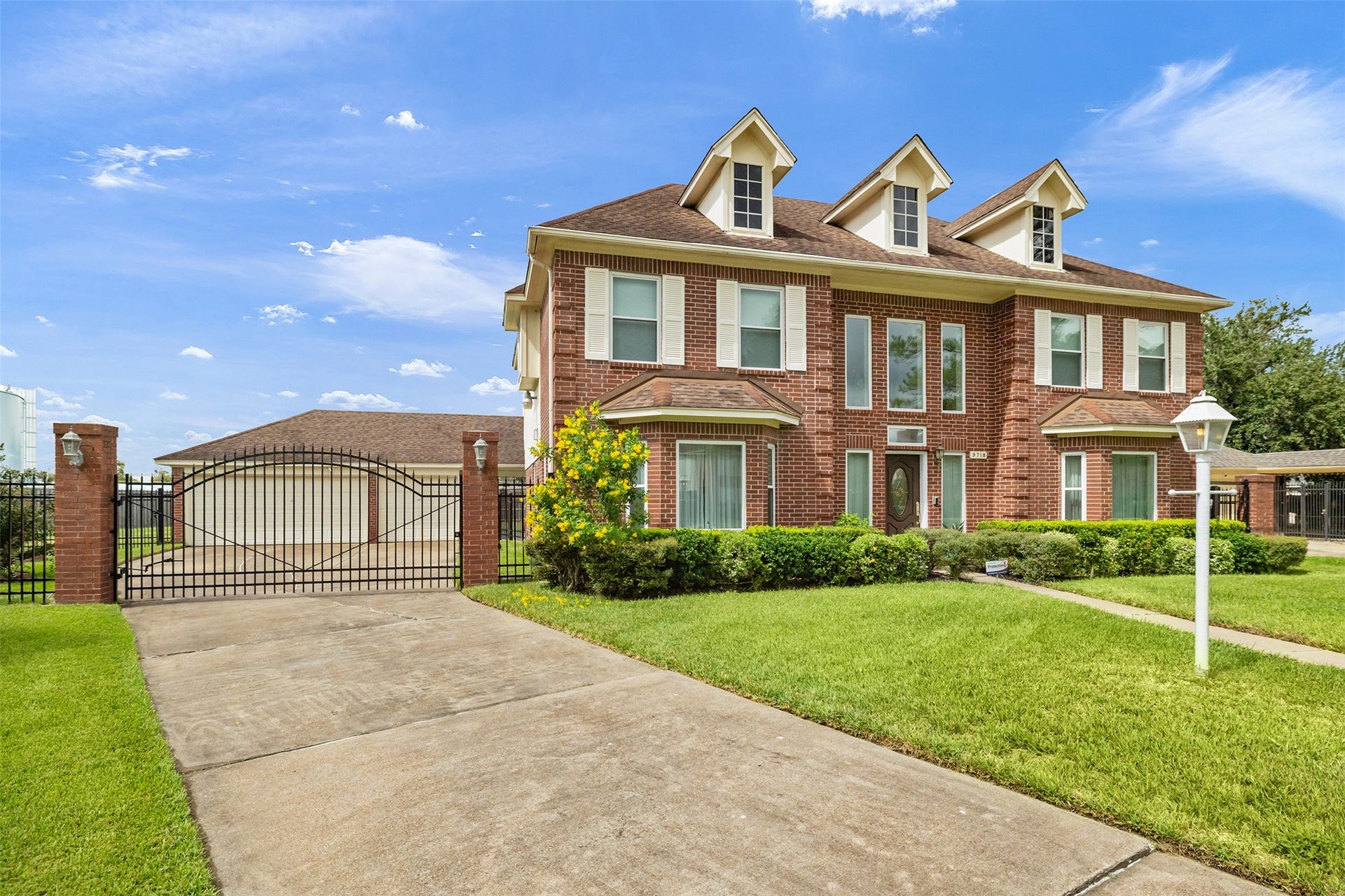 9718 Deverell Drive, Sugar Land, TX 77498 A gated driveway keeps cars and weekend projects tucked away.