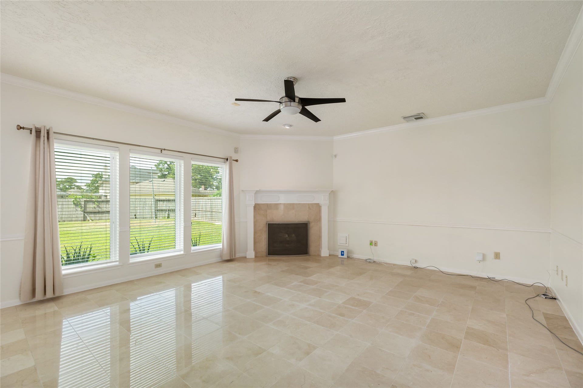 9718 Deverell Drive, Sugar Land, TX 77498 A great view of the backyard from the living room. Plus a cozy fireplace in the corner.