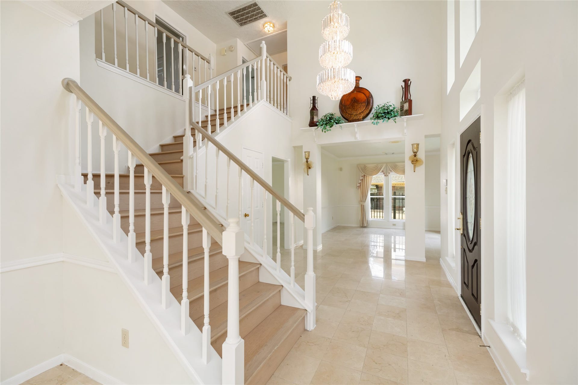 9718 Deverell Drive, Sugar Land, TX 77498 Polished marble carries past the upgraded wood staircase.