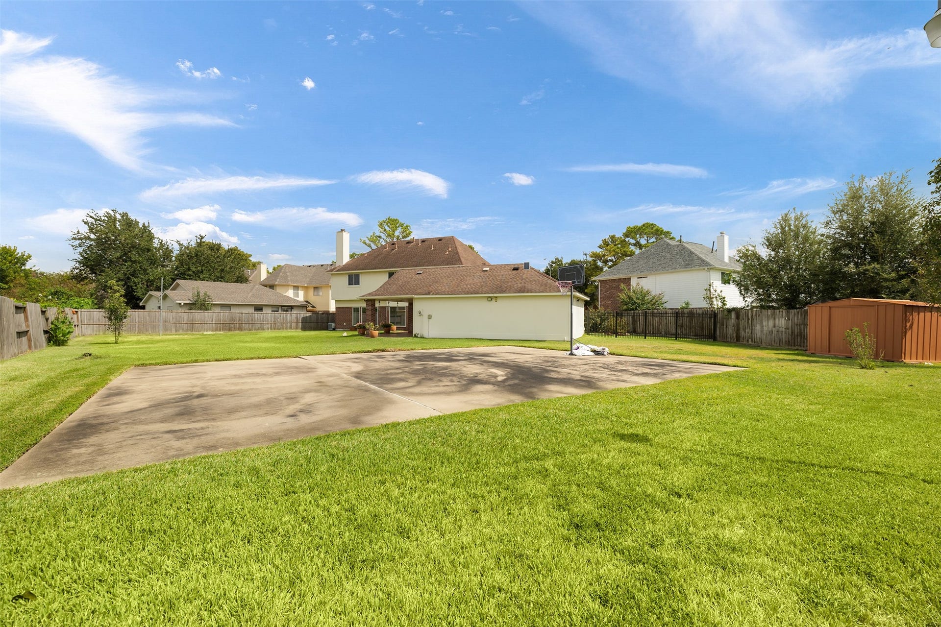 9718 Deverell Drive, Sugar Land, TX 77498 Shoot hoops under the lights on the 30' x 20' court, with a metal shed close by.