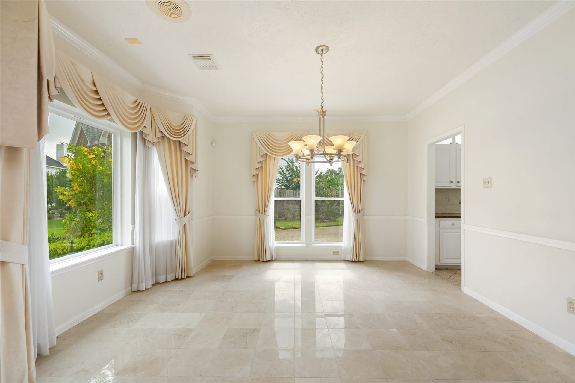 9718 Deverell Drive, Sugar Land, TX 77498 Custom draperies dress the dining room for hosting dinners.