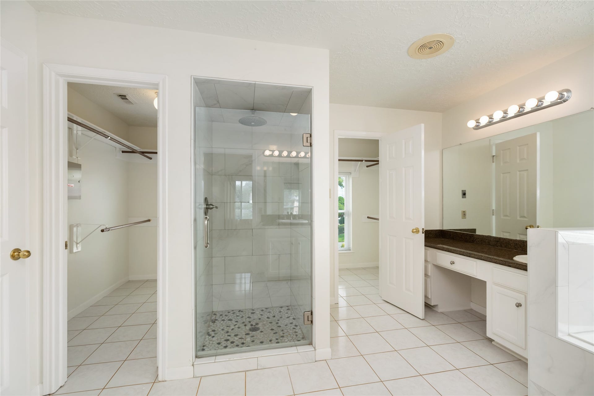 9718 Deverell Drive, Sugar Land, TX 77498 The renovated shower features a marble surround and premium showerhead.
