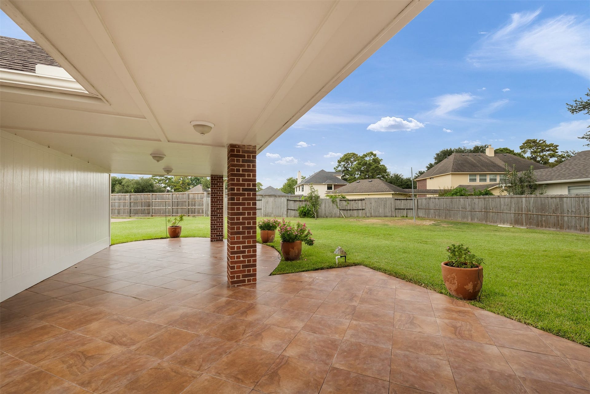 9718 Deverell Drive, Sugar Land, TX 77498 Morning coffee tastes better on the covered tile patio.
