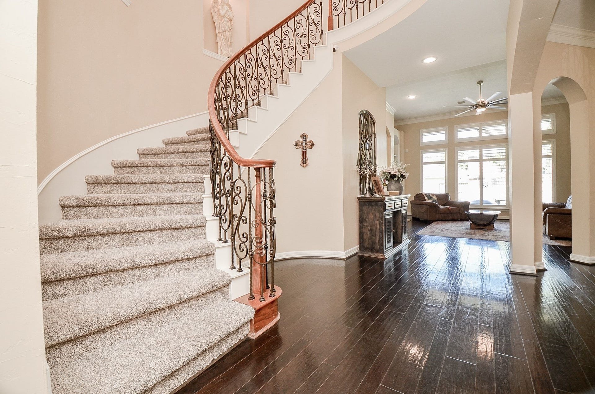 2015 Shadow Bend Drive, Sugar Land, TX 77479 Dramatic curved staircase is beautifully accented with intricate wrought iron balusters and warm wood handrails, while arched openings add softness and sophistication. New carpet on stairs.