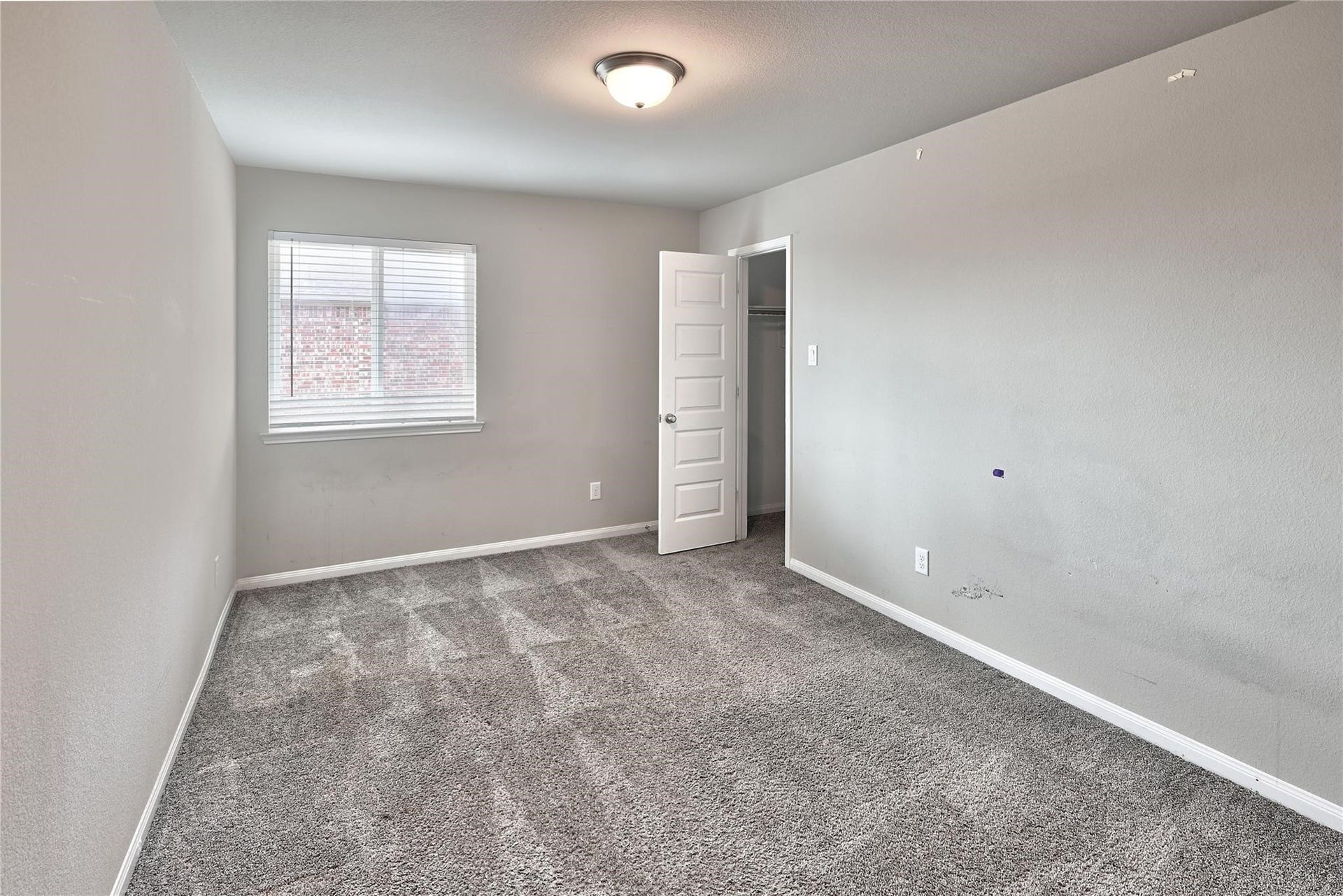 5936 Pearland Place, Pearland, TX 77581 Bright room with gray carpet and neutral walls, featuring large windows for natural light and a pleasant view.