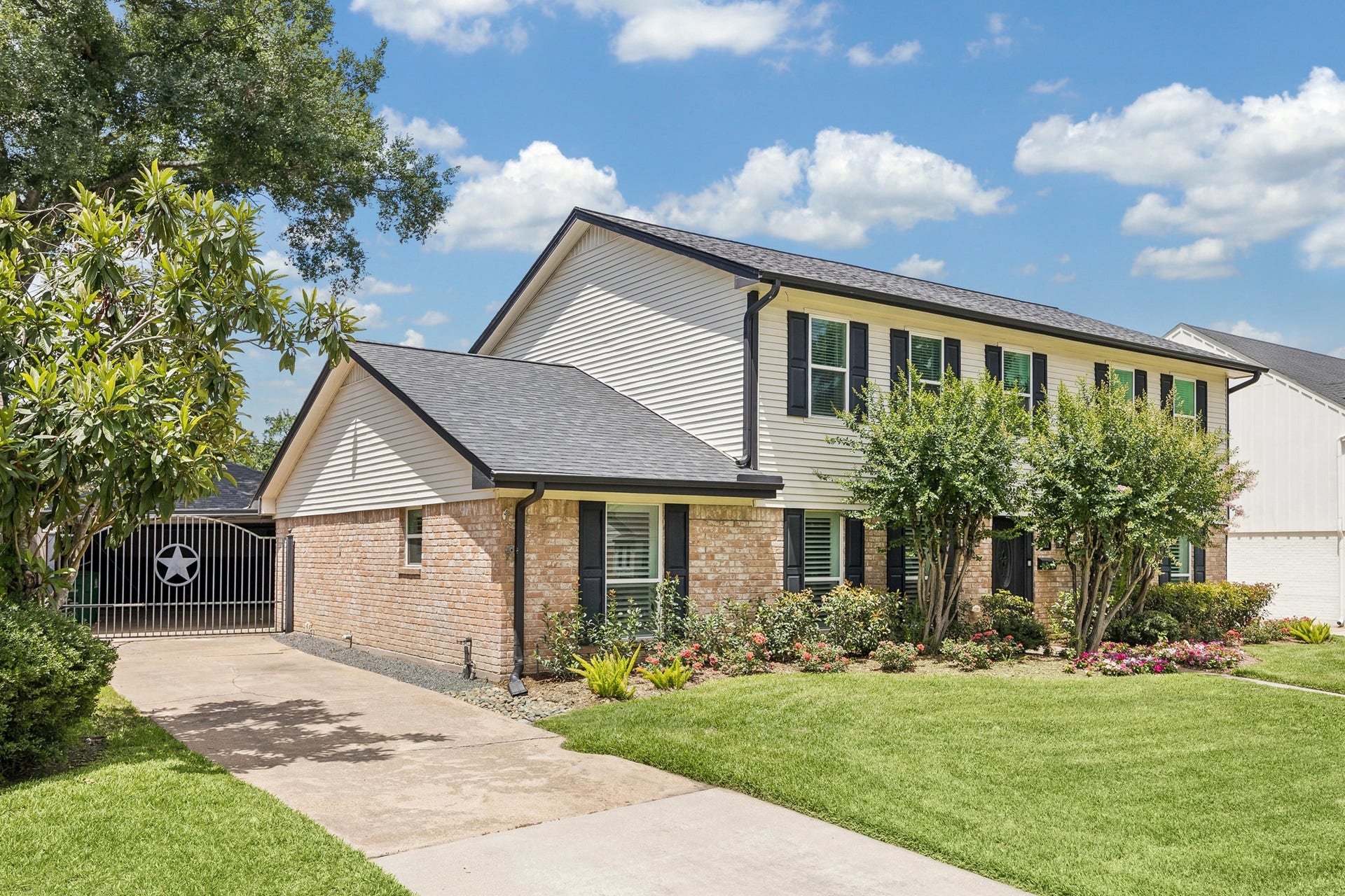 1022 Martin Street, Houston, TX 77018 Home features a wide gated drive with shaded covered parking and double garage. Extra details include easy maintenance gravel along the drive, irrigation system, and a 2023 Roof.