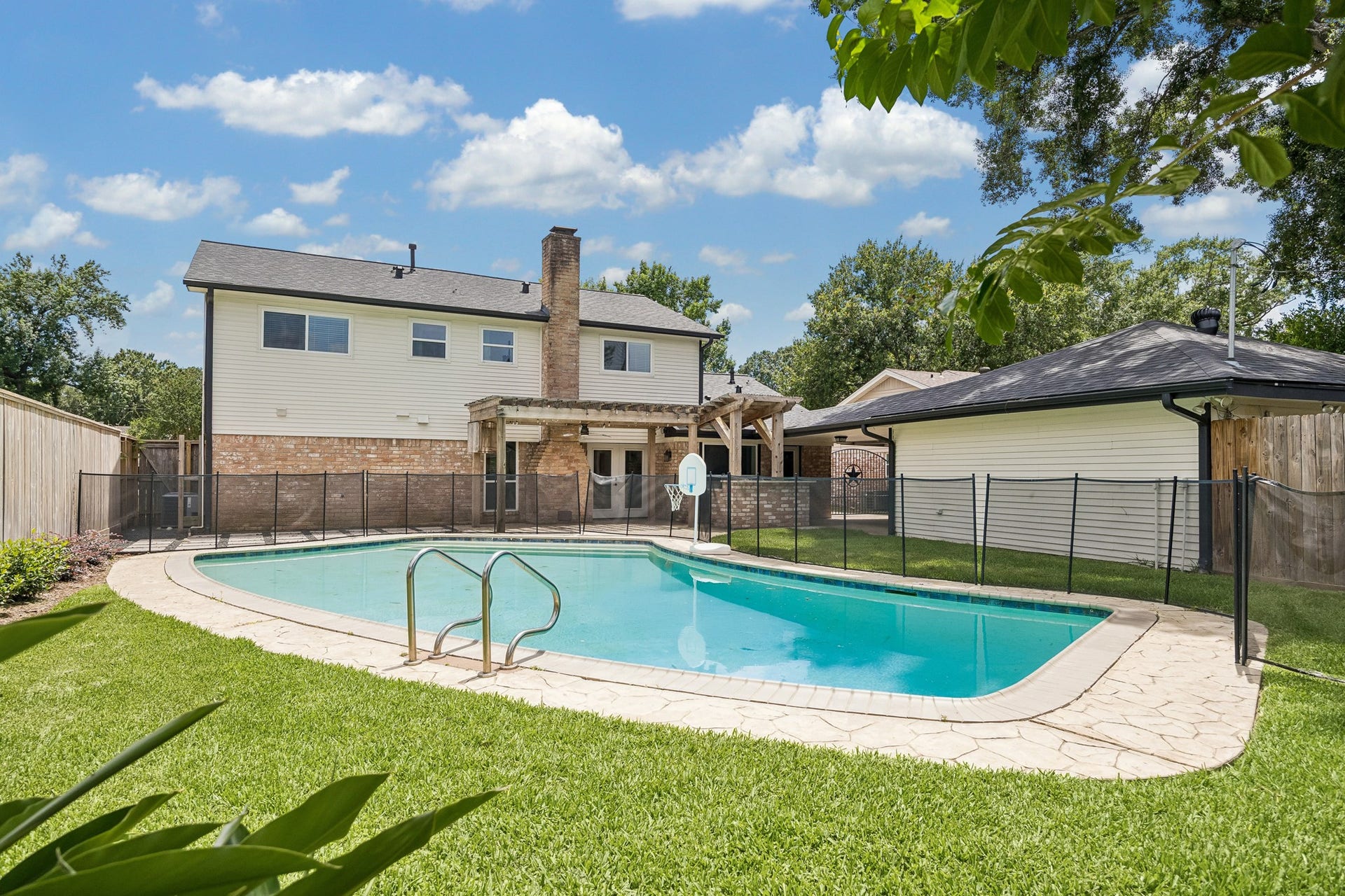 1022 Martin Street, Houston, TX 77018 The oversized back yard has a large pool, outdoor kitchen, seating area under a custom pergola, and firepit area adjacent.