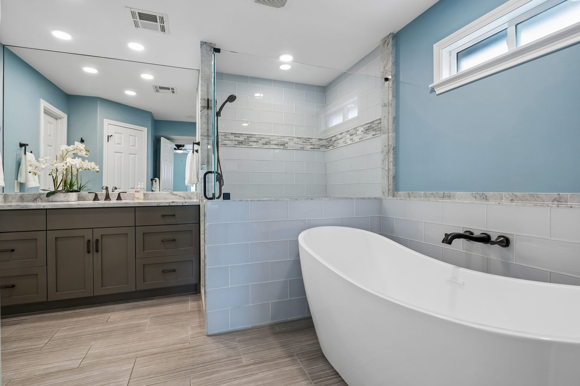 1022 Martin Street, Houston, TX 77018 The beautiful lines of the soaking tub juxtapose the clean shaker lines of the cabinetry. Soft grey stain wash and lovely tile accents complete the look.
