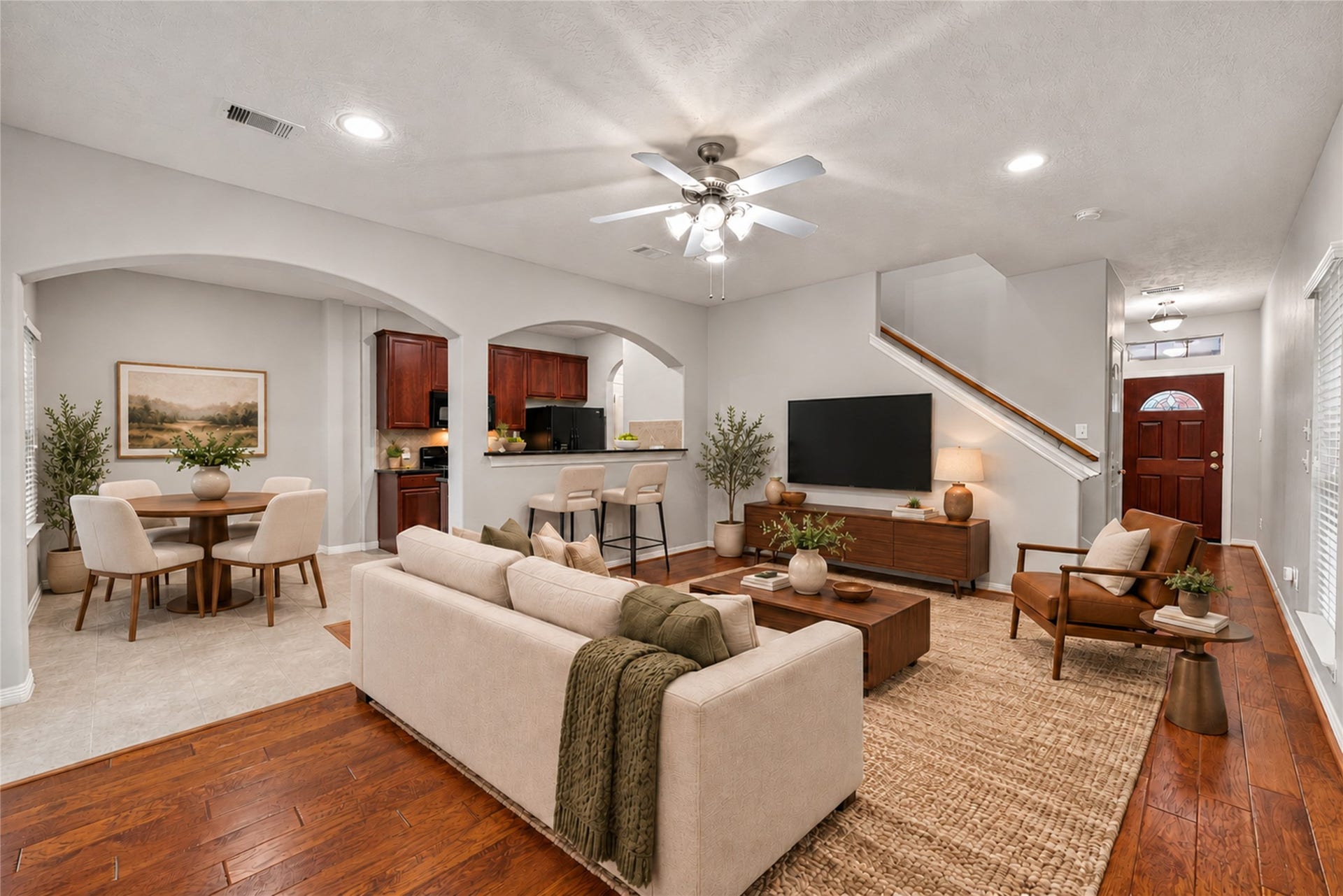 8910 Minola Oaks Drive, Houston, TX 77064 Virtually staged living room open to kitchen and dining area.