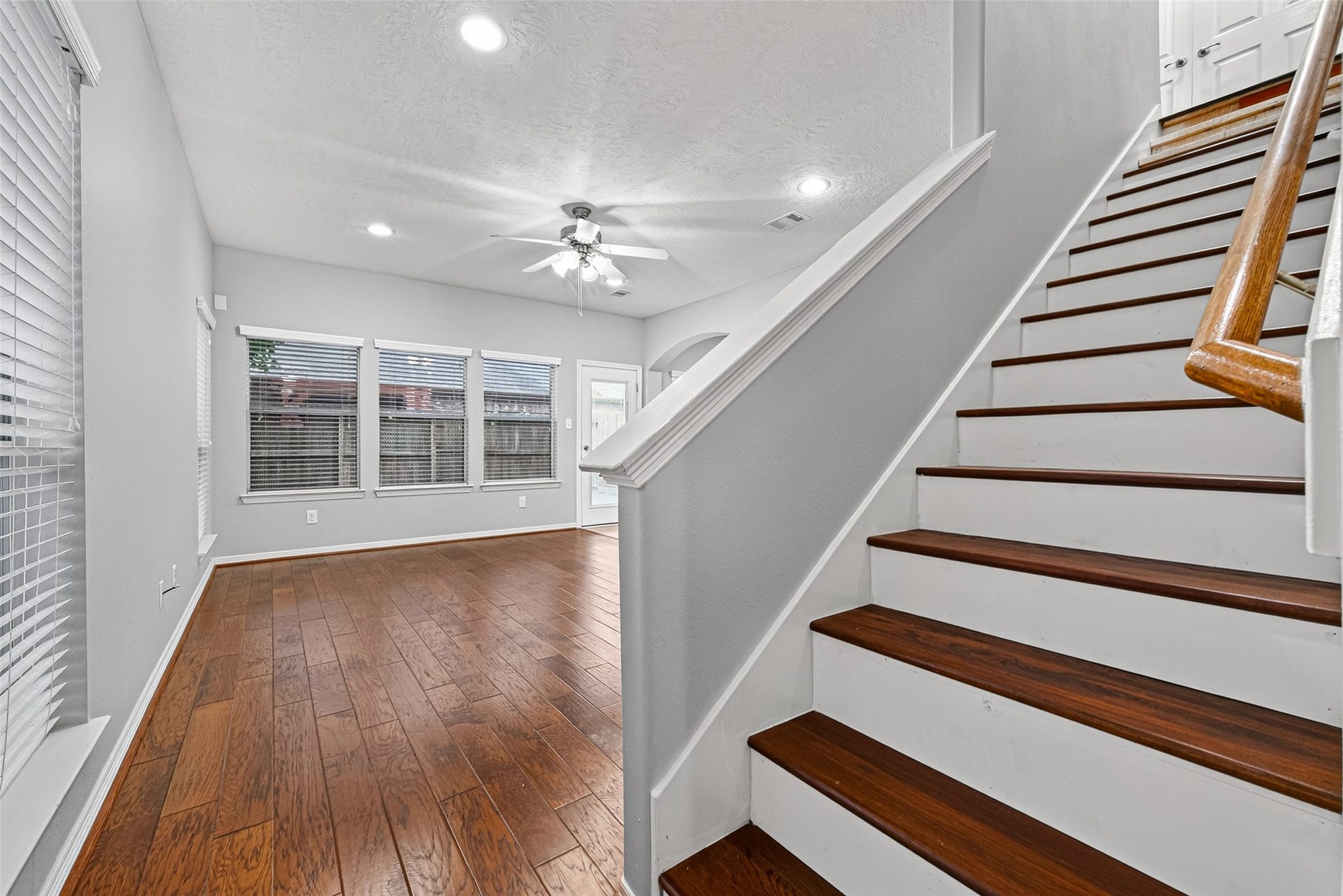 8910 Minola Oaks Drive, Houston, TX 77064 Wood floors in the living room and oak steps lleading to the three bedrooms.