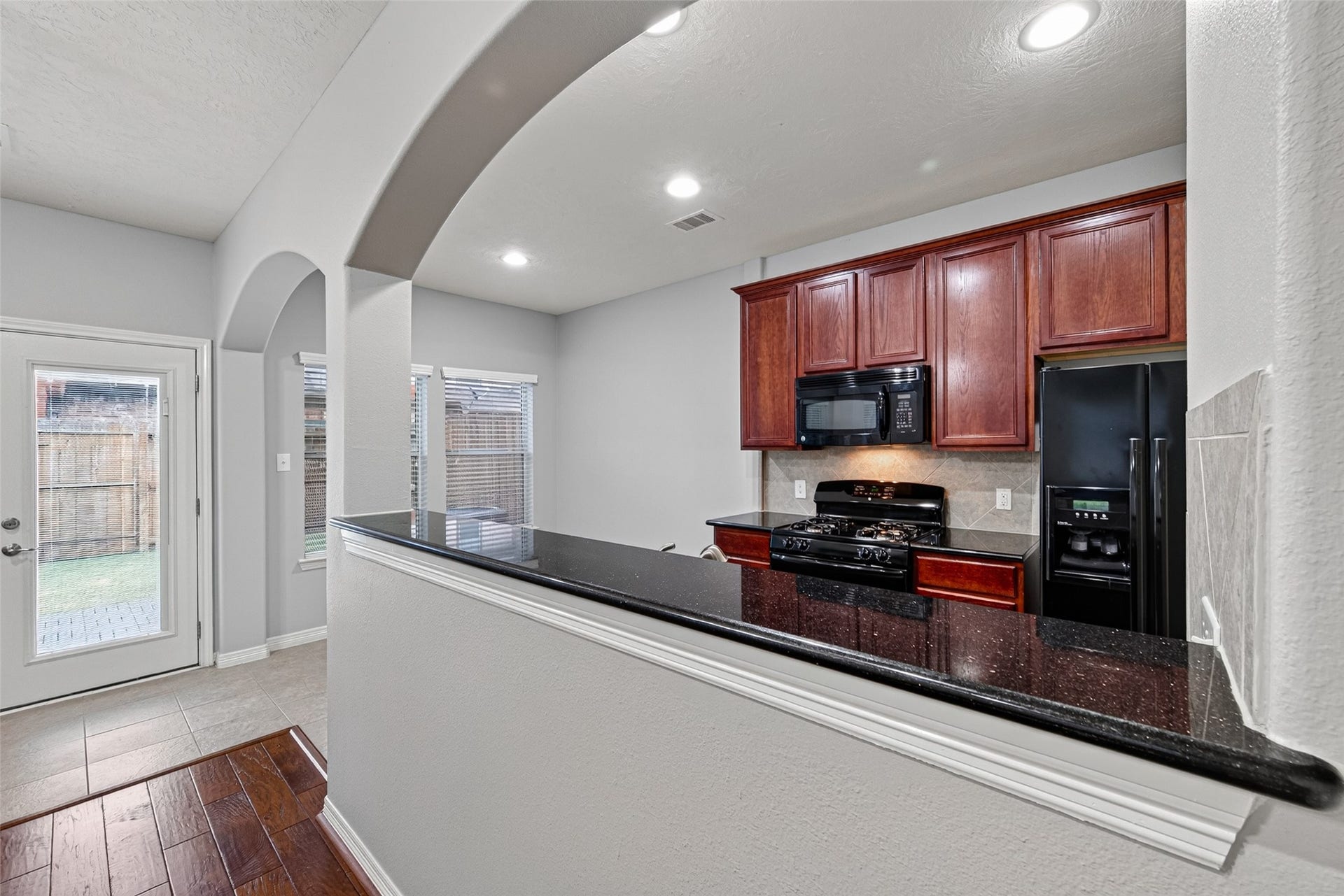 8910 Minola Oaks Drive, Houston, TX 77064 The living room is open to the kitchen, and the arches give personality to the place.